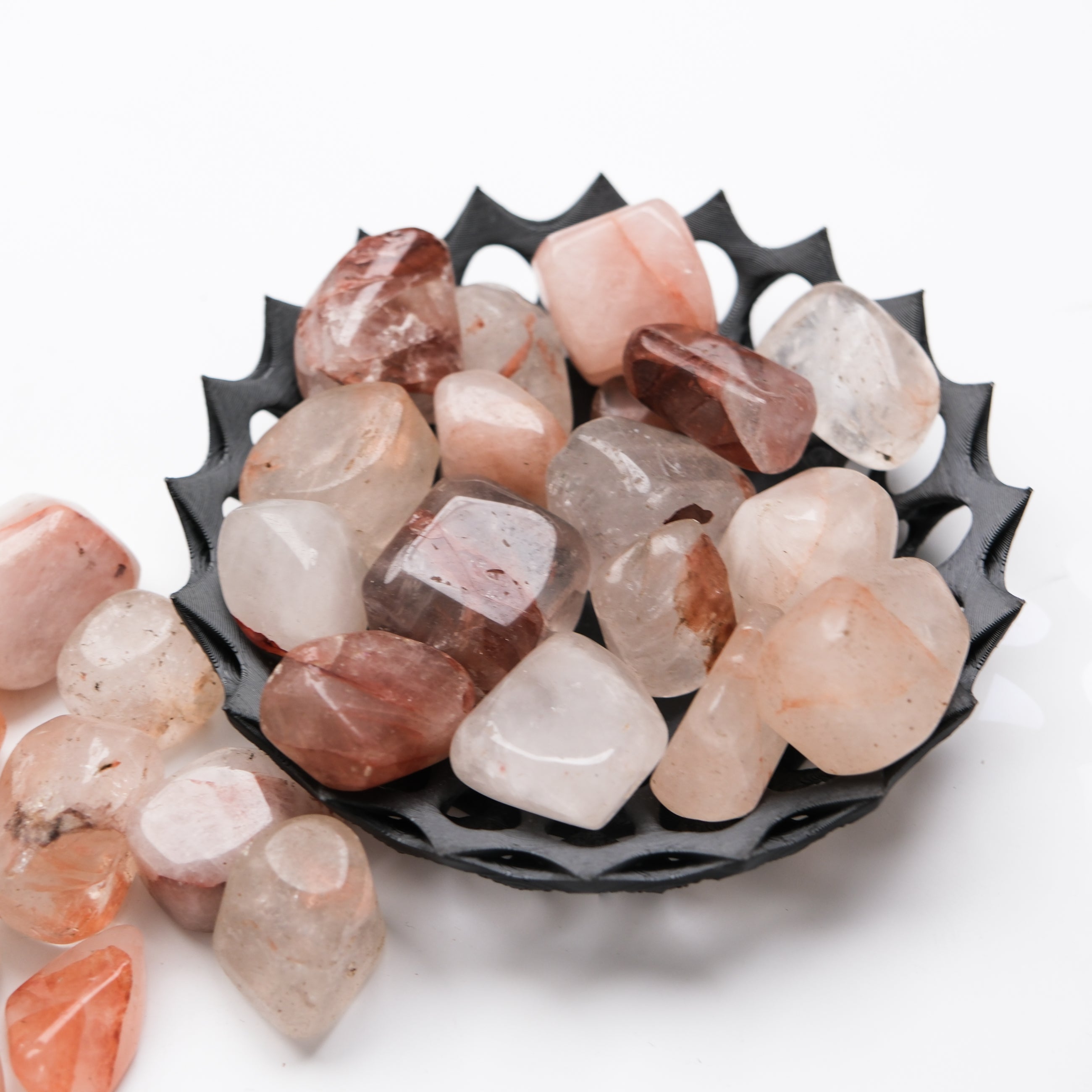 Hematoid Quartz tumble stone from Noctis Studio showcasing its polished, reddish-brown and clear mineral appearance.