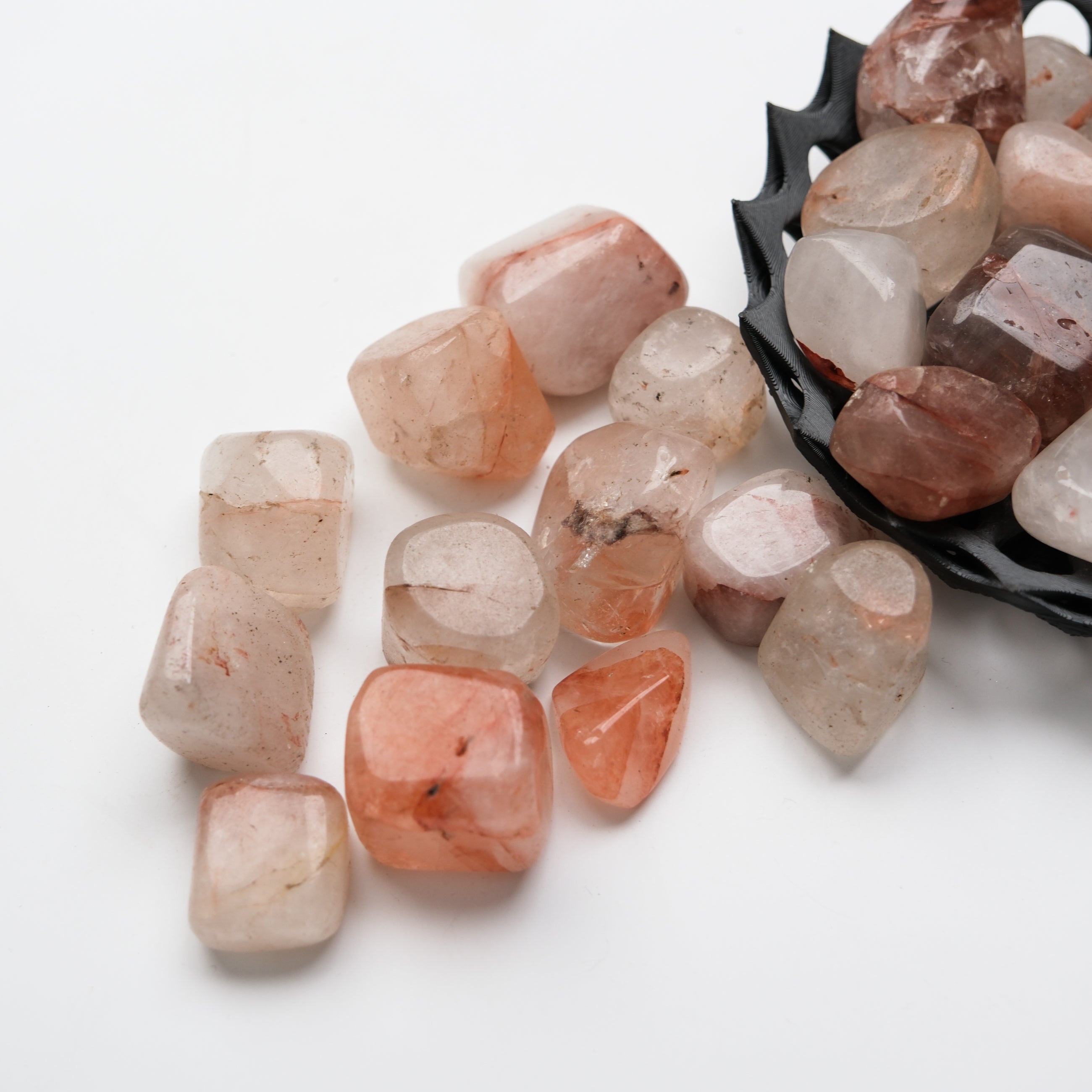 Hematoid Quartz tumble stone from Noctis Studio showing a polished, reddish-brown mineral with natural streaks and inclusions.