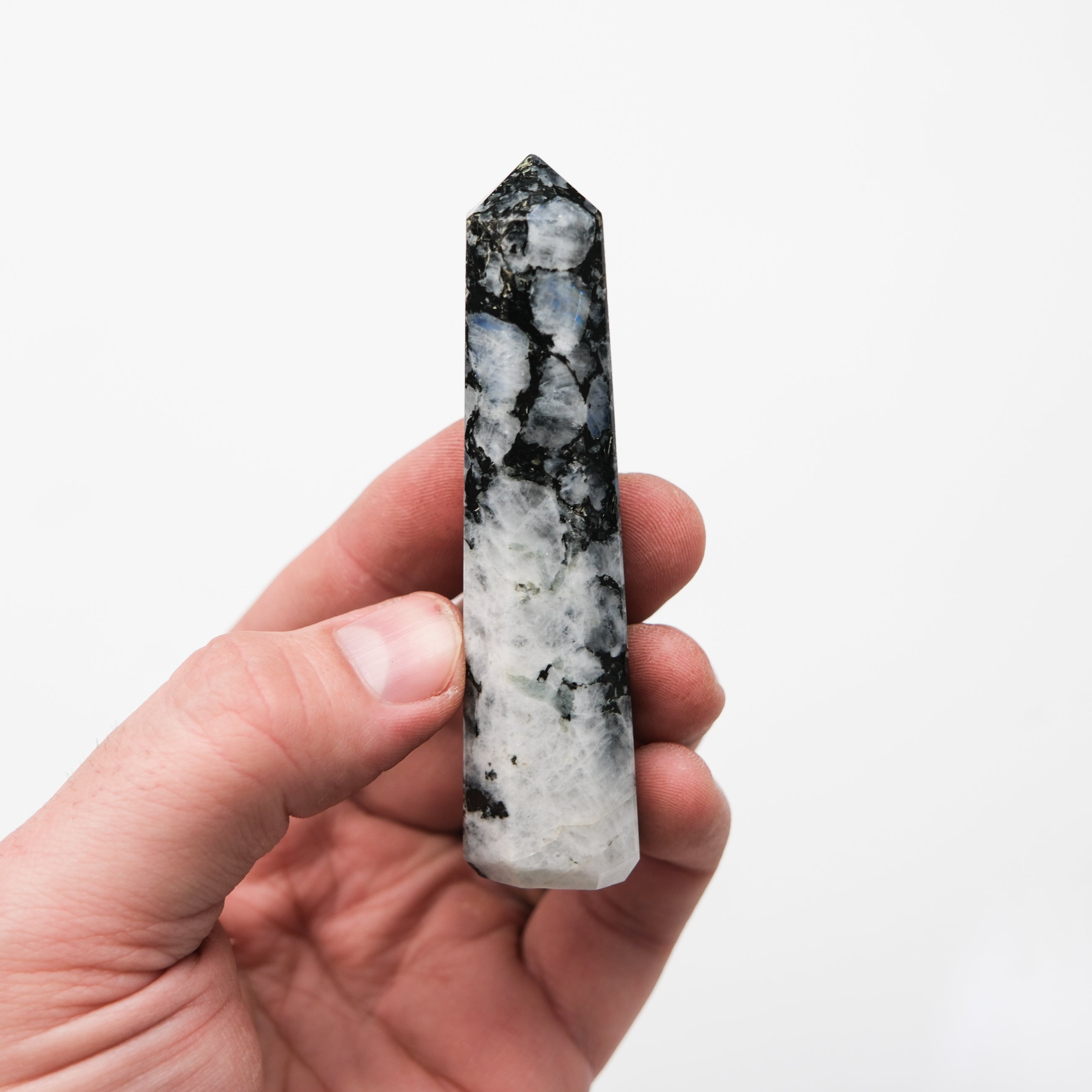 Noctis Studio moonstone point pillar with smooth, polished surface and natural gemstone appearance, displayed on a white background.