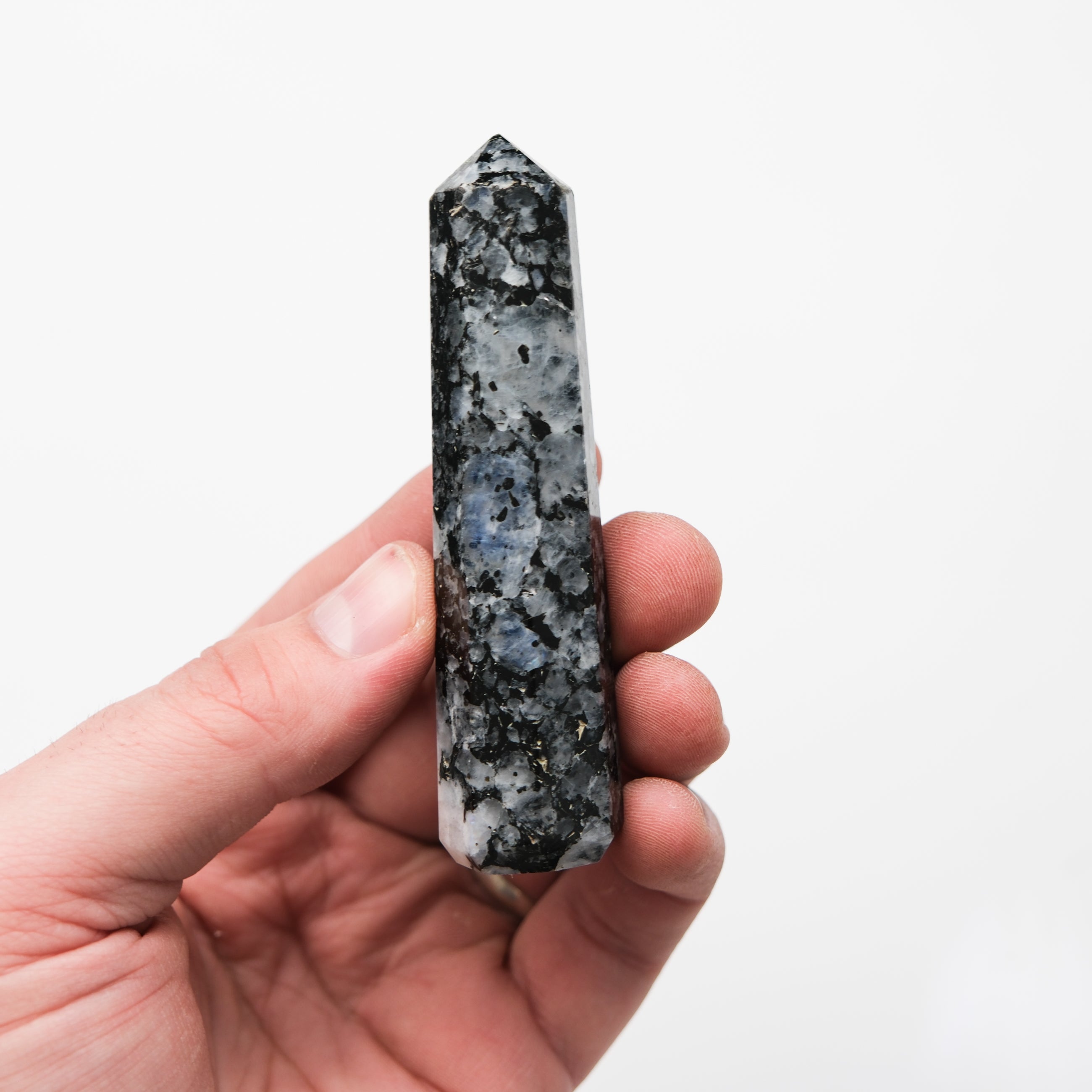 Noctis Studio moonstone point pillar, polished gemstone with a smooth, translucent surface and natural lunar-like patterns.