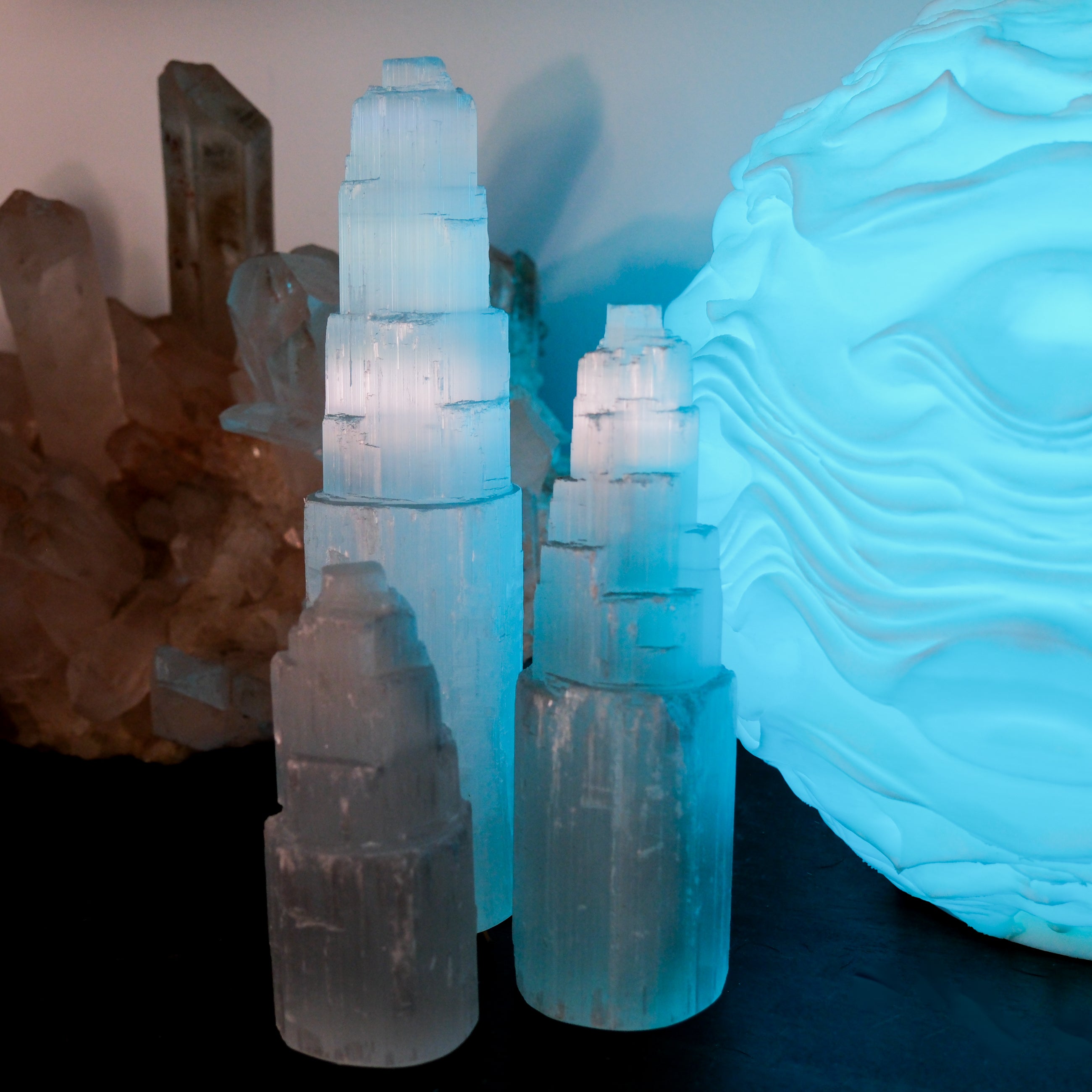 Selenite pillar from Noctis Studio showing a white, translucent crystal with smooth, polished surface and natural stone texture.