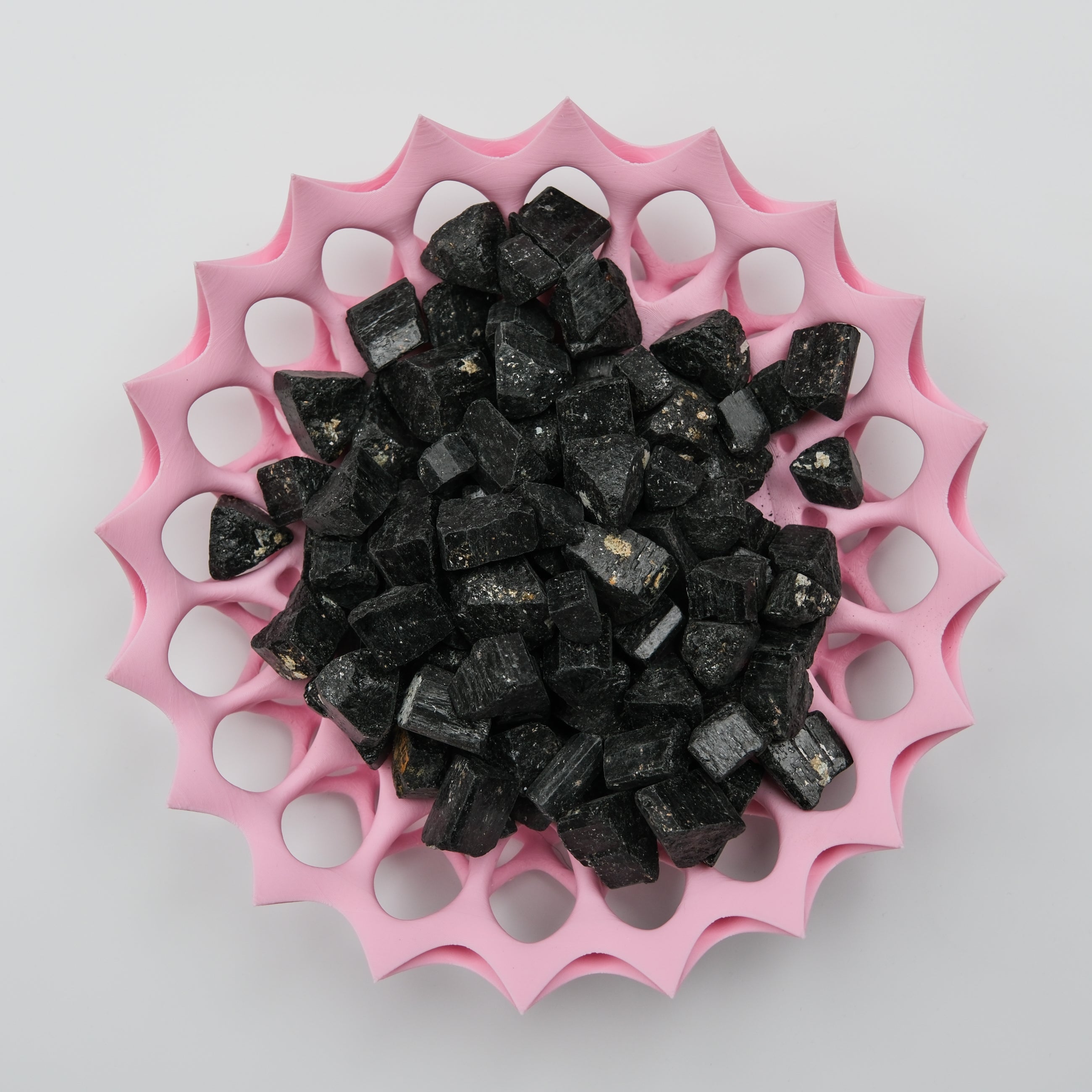 Rough black tourmaline stone from Noctis Studio with natural, unpolished surface and deep black color.