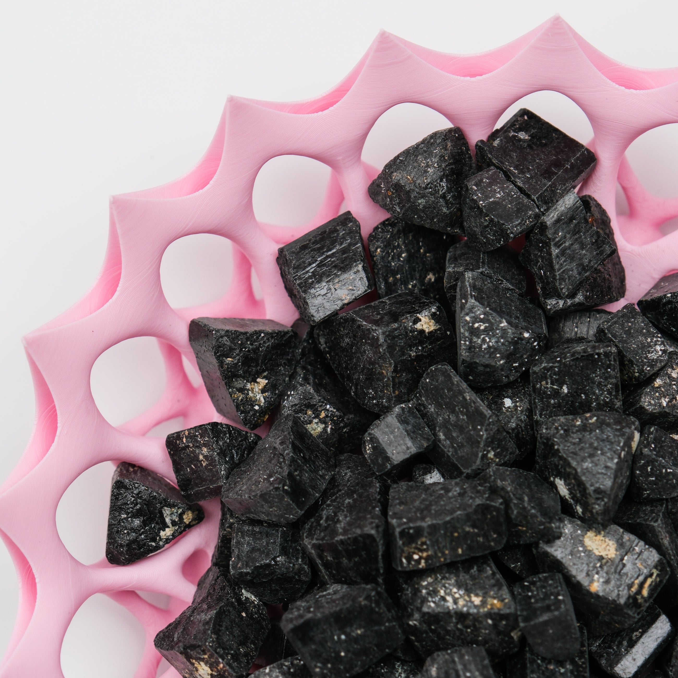 Rough black tourmaline stone from Noctis Studio, showcasing a textured, matte black mineral with natural crystalline formations.