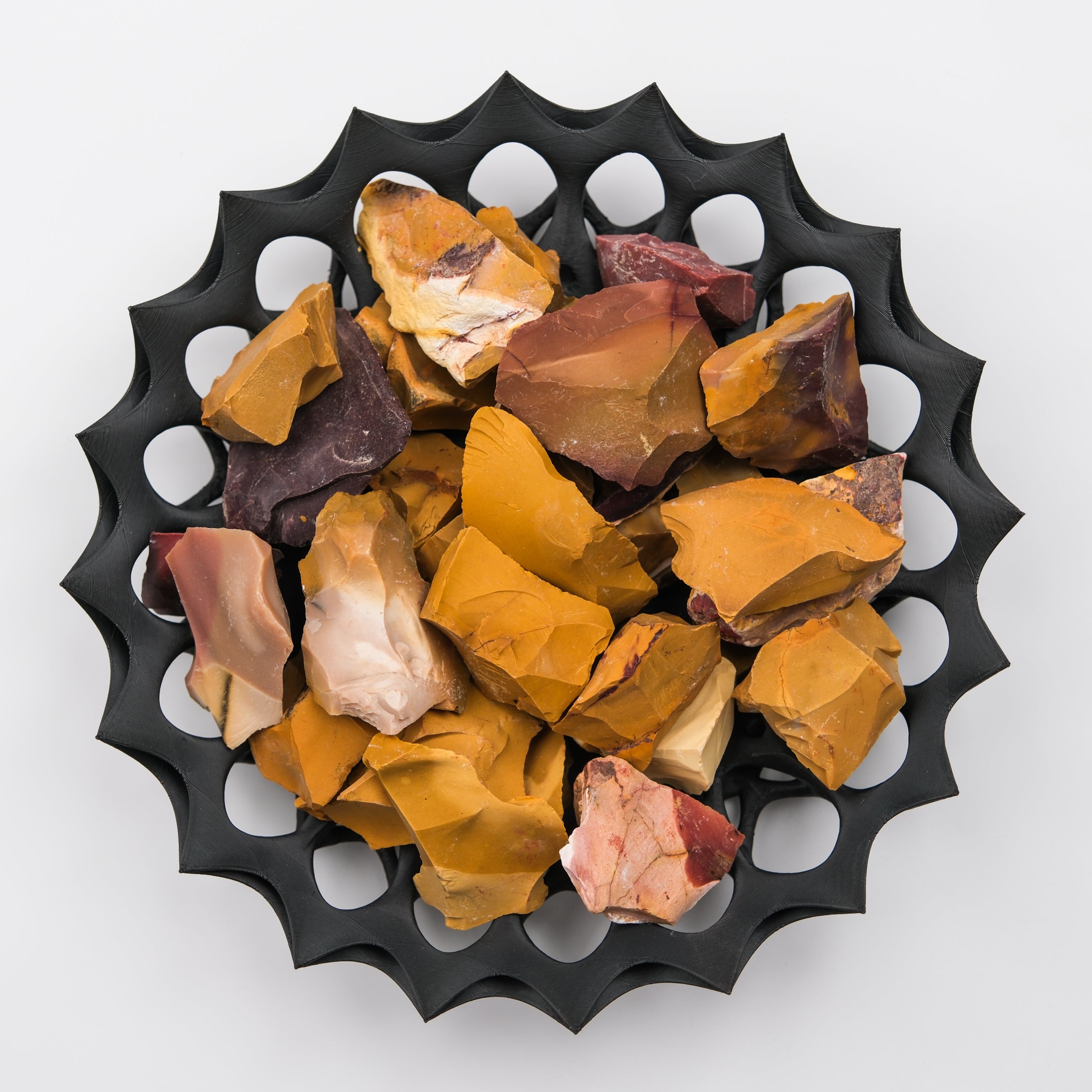 Natural Mookaite rough gemstone from Noctis Studio, featuring vibrant earthy tones and a textured, unpolished surface.
