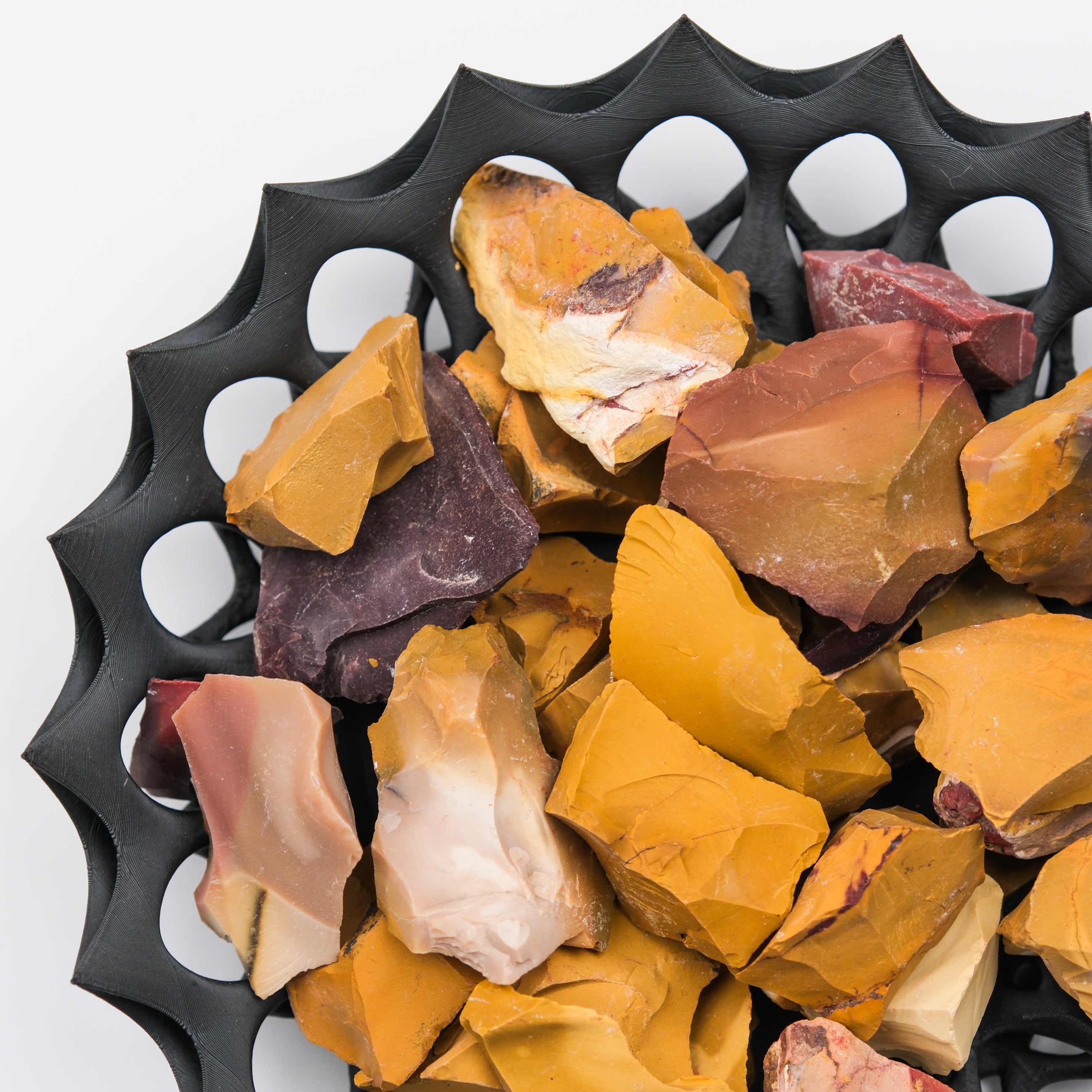 Rough Mookaite gemstone from Noctis Studio, showcasing vibrant earthy tones and natural mineral texture in a close-up shot.