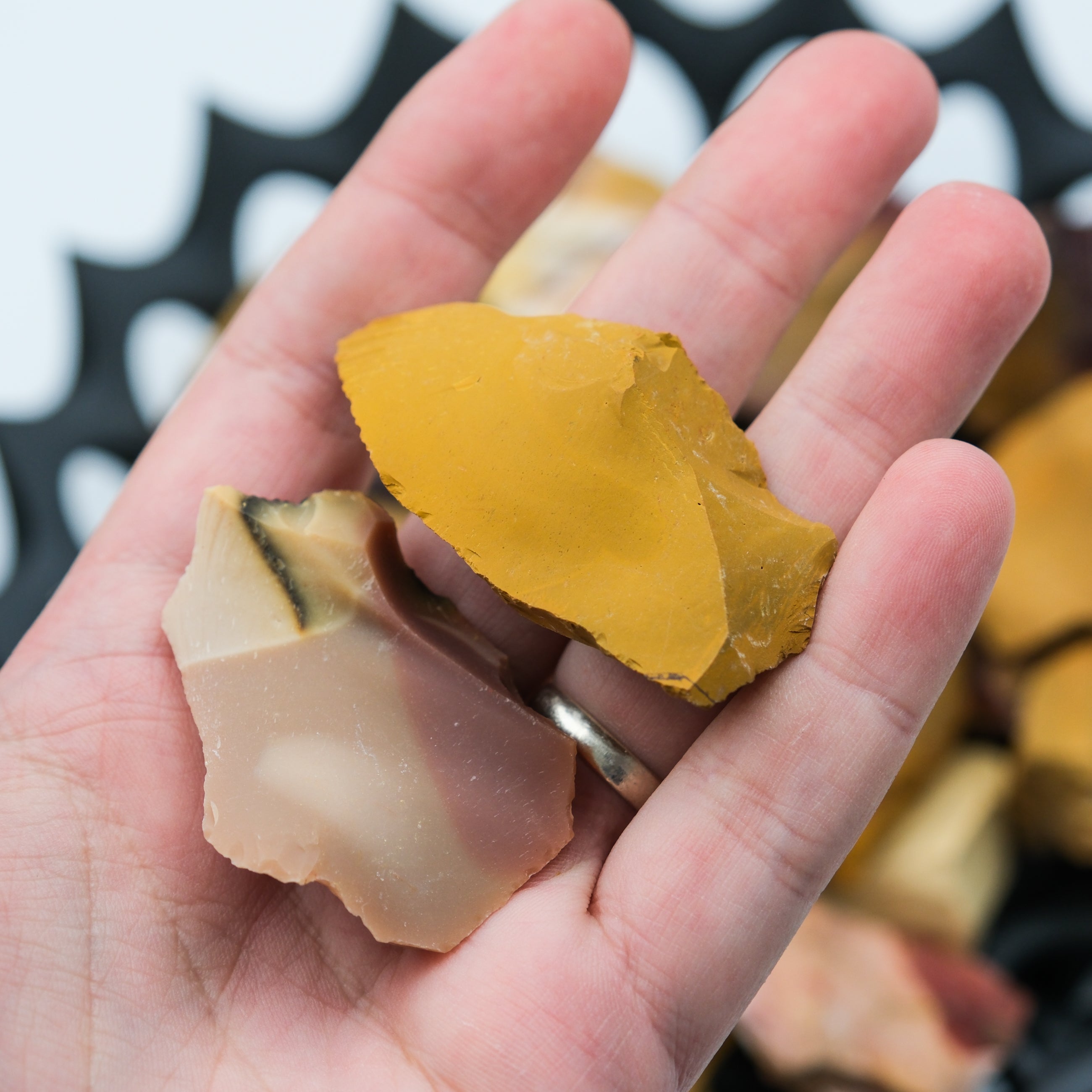 Natural Mookaite rough gemstone from Noctis Studio, showcasing earthy tones and jagged, unpolished stone surface.