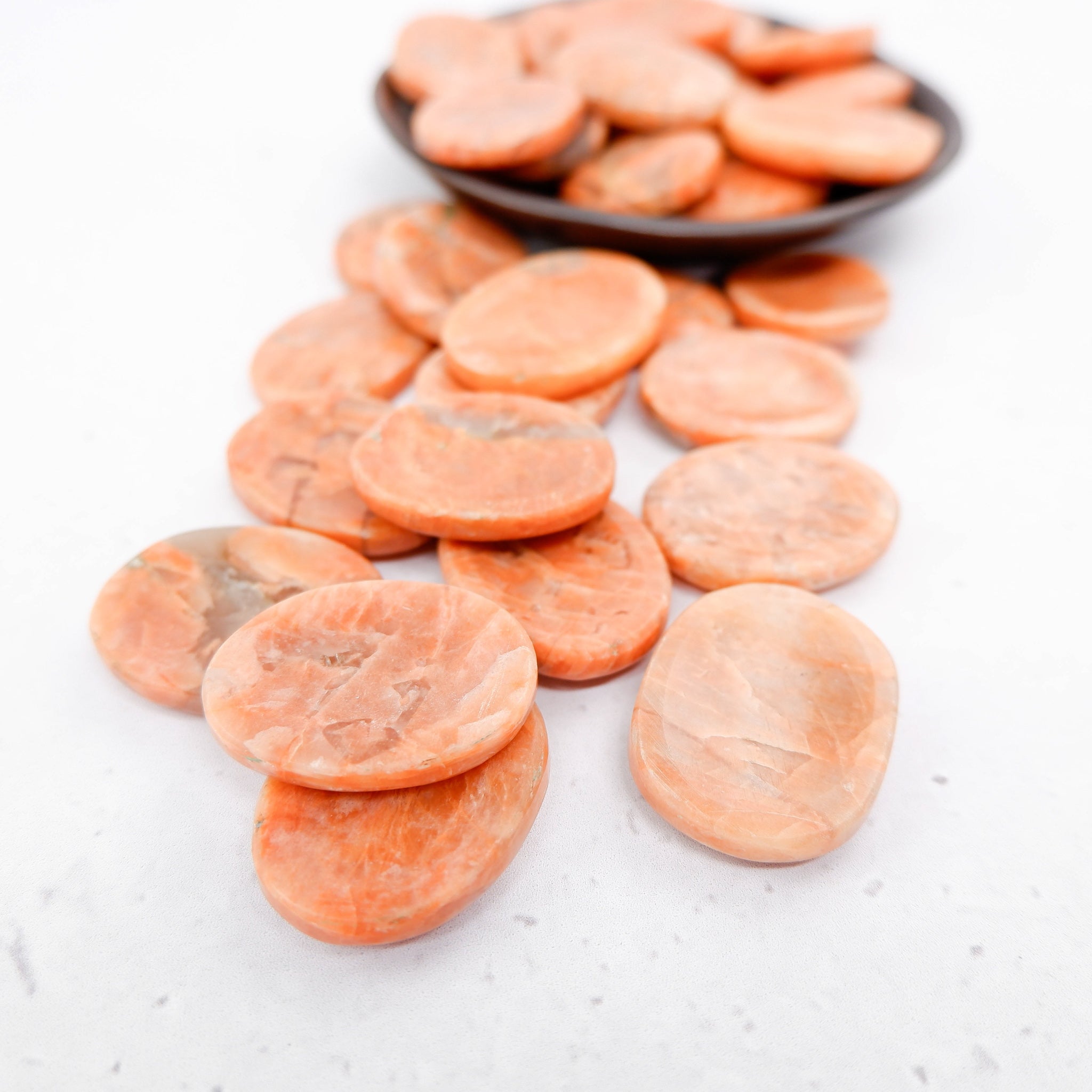 Orange moonstone worry stone from Noctis Studio featuring smooth, polished gemstone with vibrant orange hues and unique natural patterns.