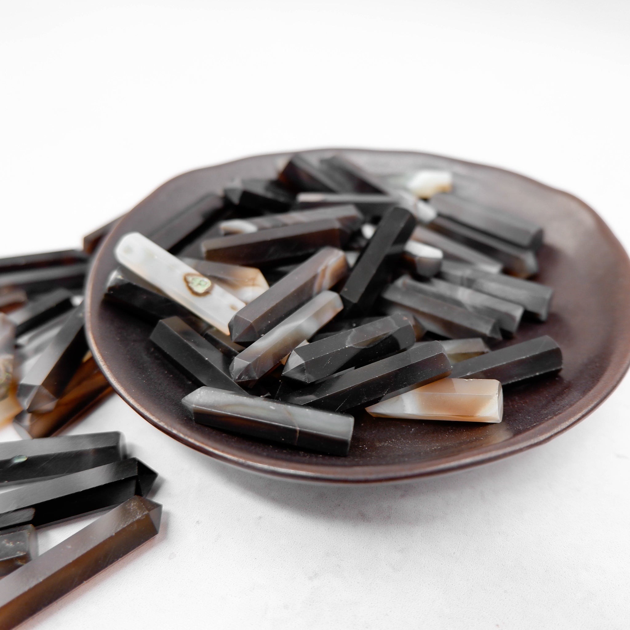 Black Sulemani Agate single gridding point from Noctis Studio, featuring polished black agate with pointed tip for precise crystal setting.