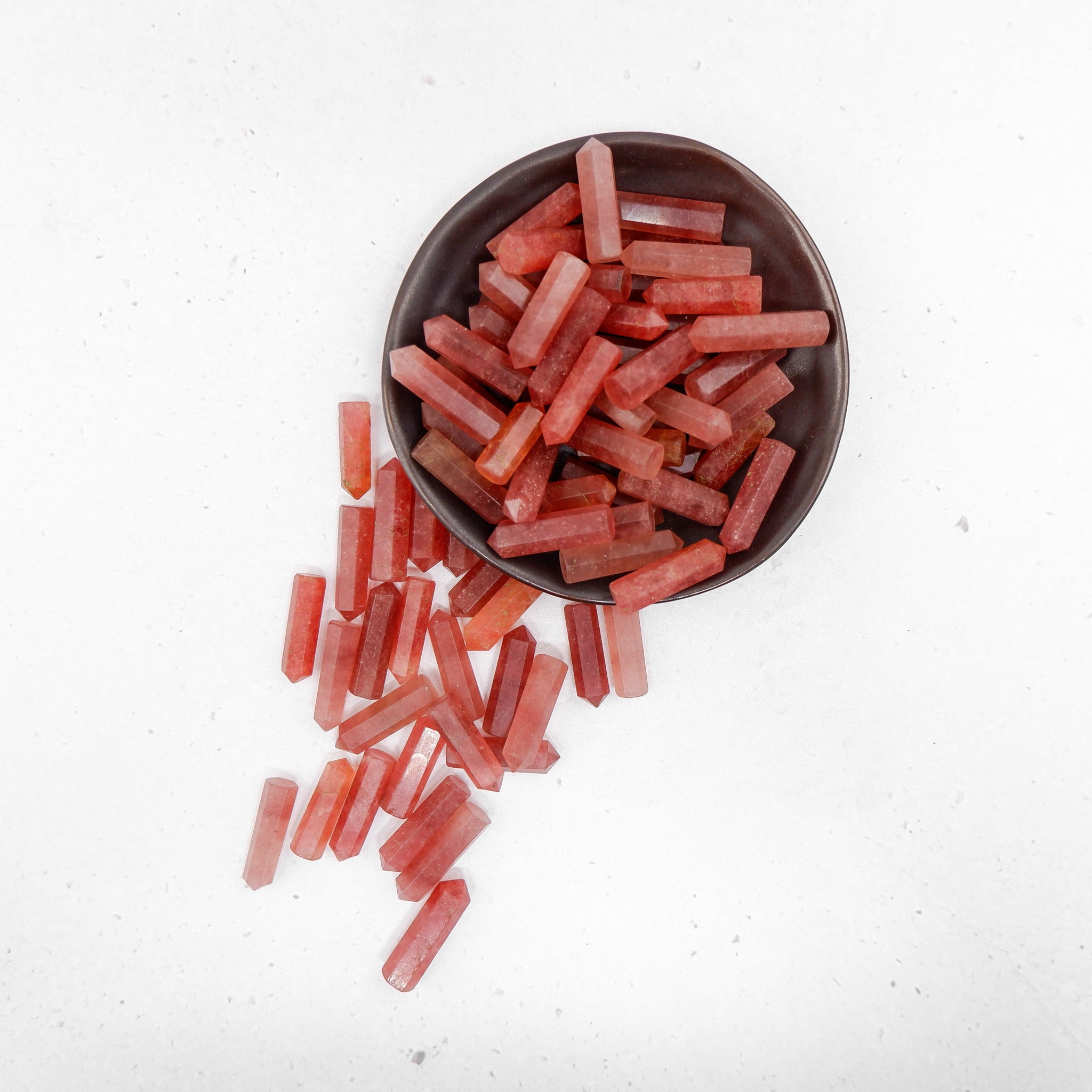 Strawberry Quartz single gridding point from Noctis Studio, featuring a polished, pointed crystal with deep pink hues.