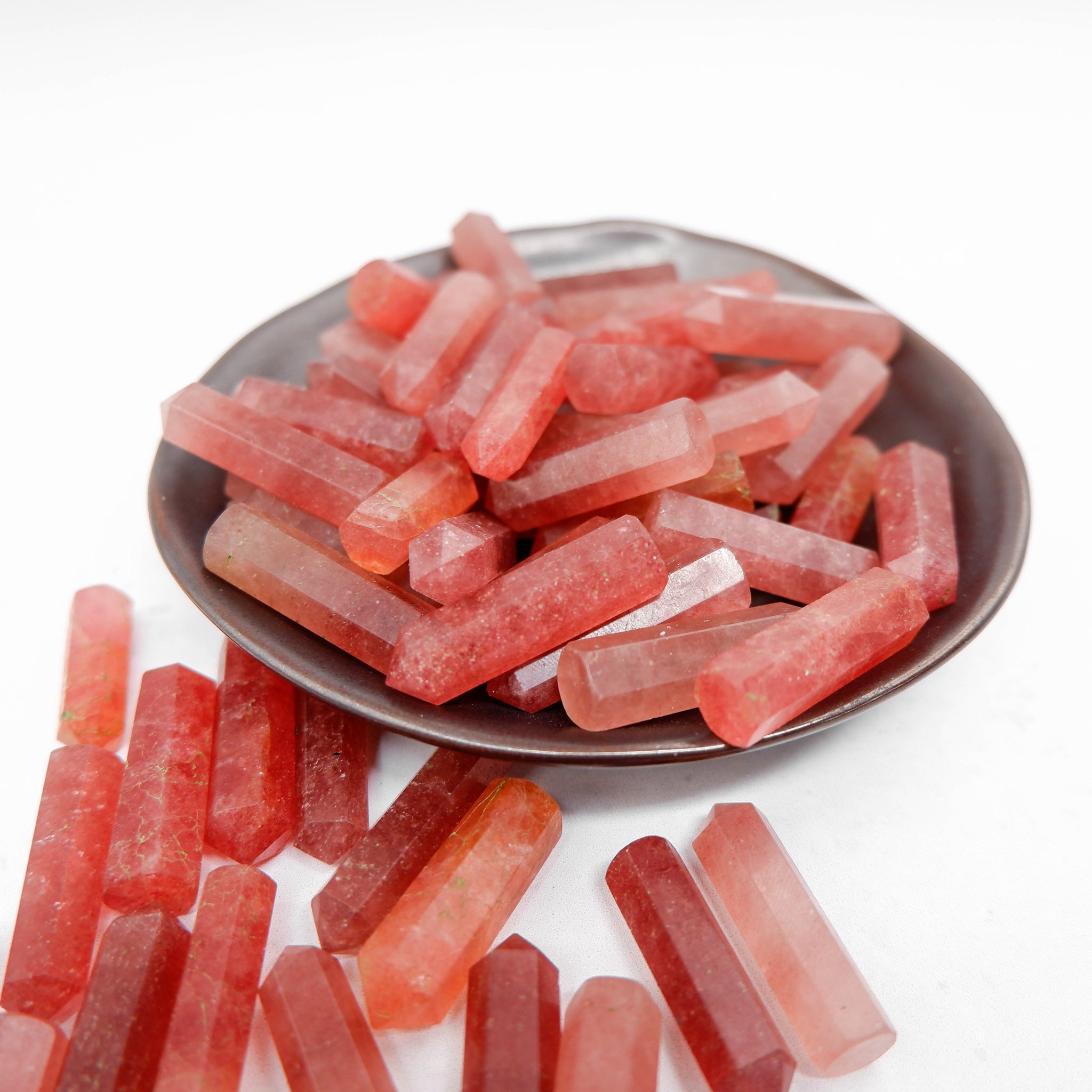 Strawberry Quartz single gridding point by Noctis Studio, featuring a polished crystal with a pointed tip and vibrant pink hue.
