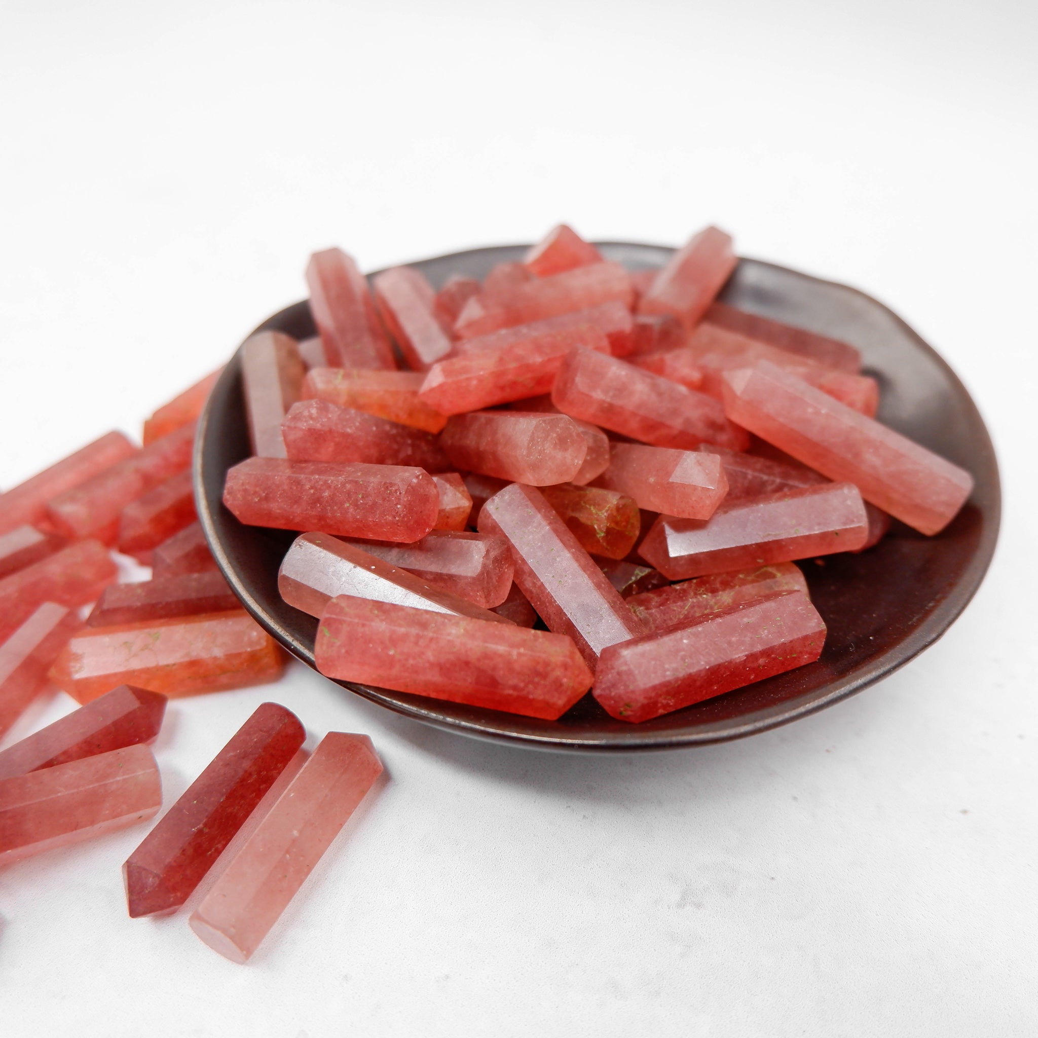 Strawberry Quartz single gridding point by Noctis Studio, showcasing a polished gemstone with vibrant red and pink hues.