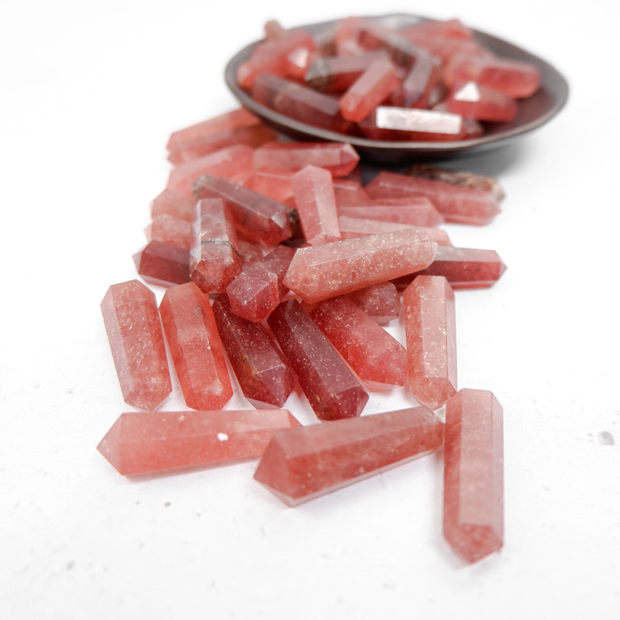 Strawberry Quartz Double Gridding Point from Noctis Studio, a polished gemstone tool with intricate grid pattern and vibrant pink color.