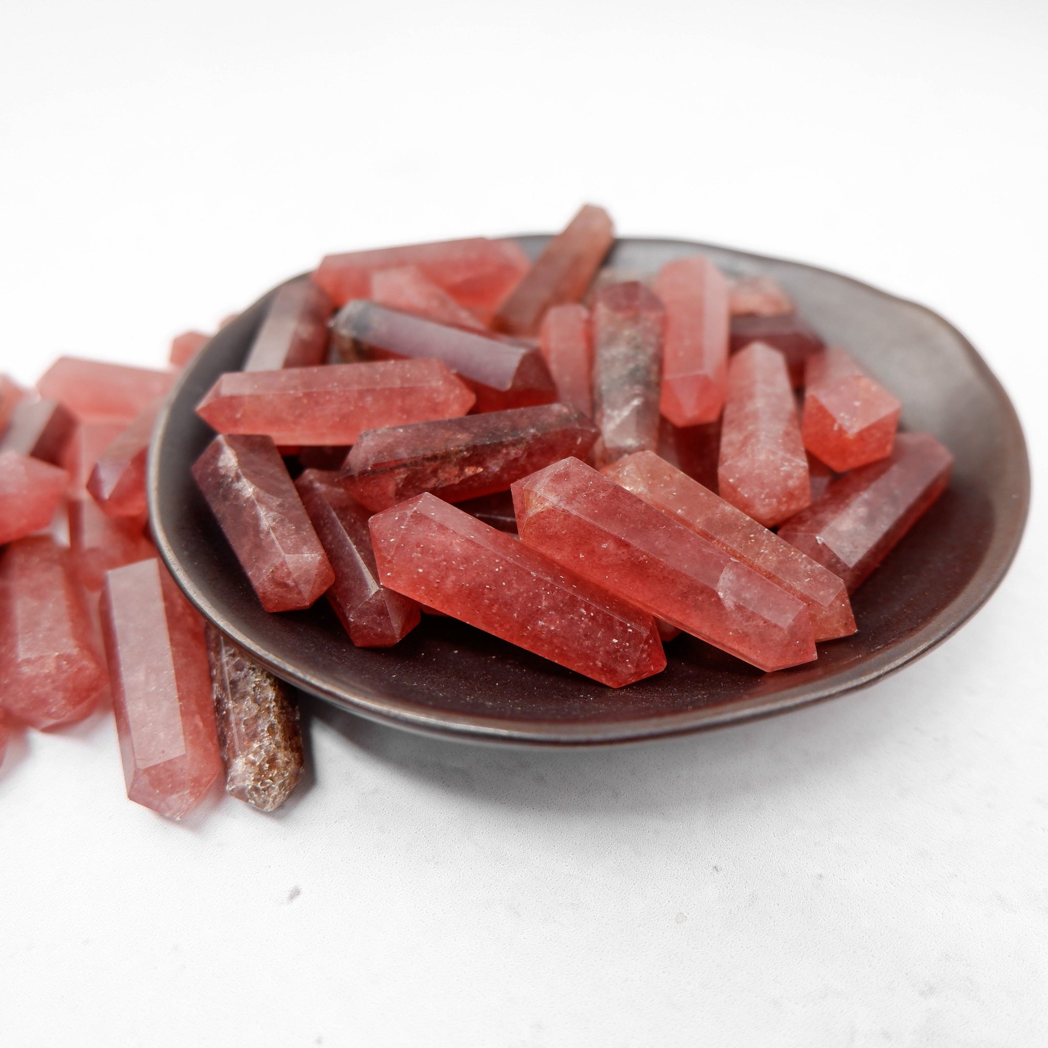 Strawberry Quartz Double Gridding Point from Noctis Studio, a polished gemstone with a pointed shape for crystal healing and decor.