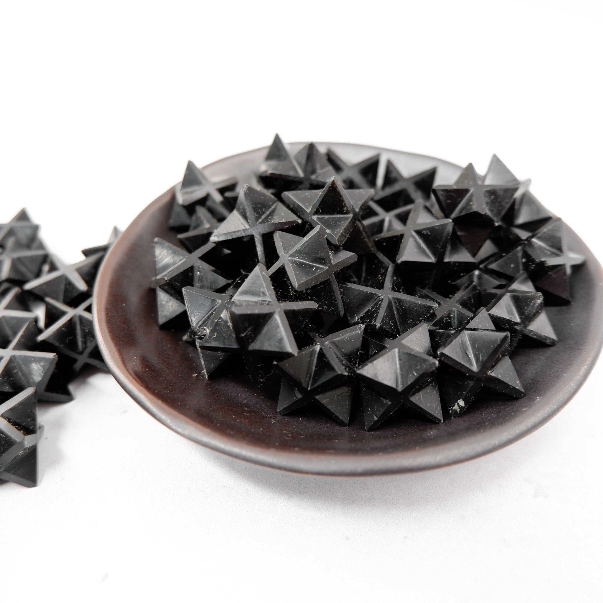 Black Jasper Star by Noctis Studio, a polished black jasper gemstone shaped into a star with natural stone patterns and a smooth finish.