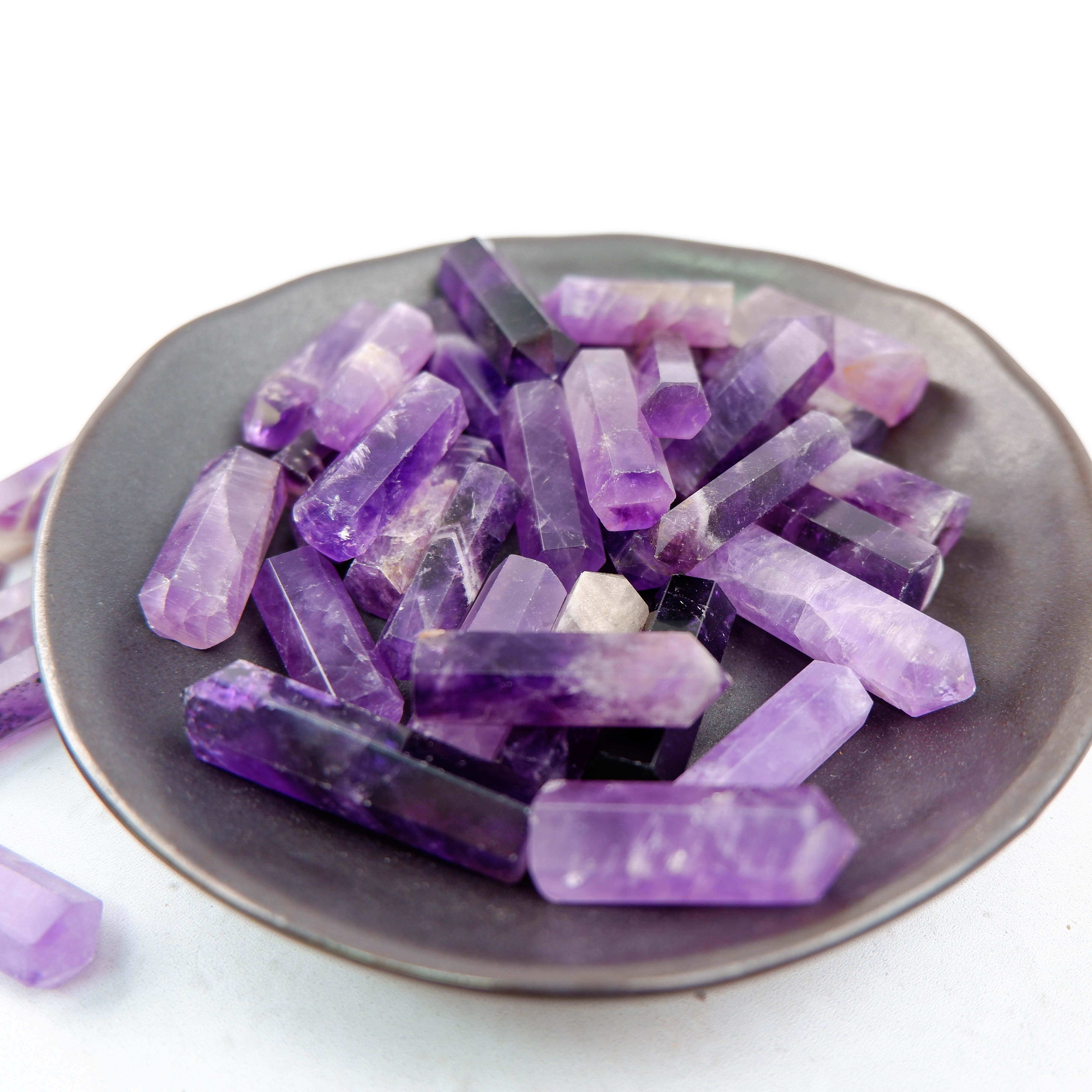 Amethyst single gridding point from Noctis Studio, featuring a polished purple crystal for gemstone crafting and jewelry making.