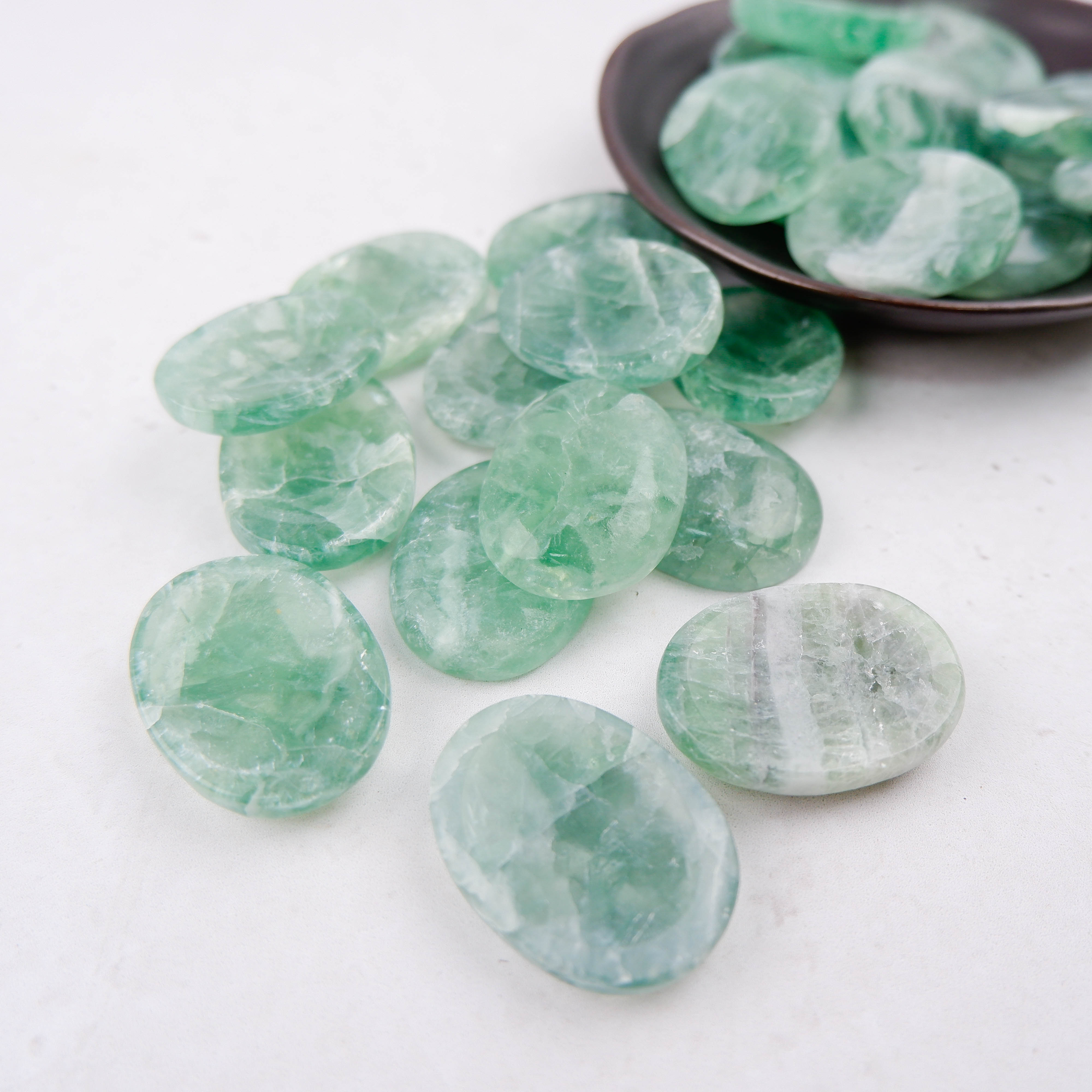 Green fluorite worry stone from Noctis Studio, smooth polished gemstone for stress relief and meditation.