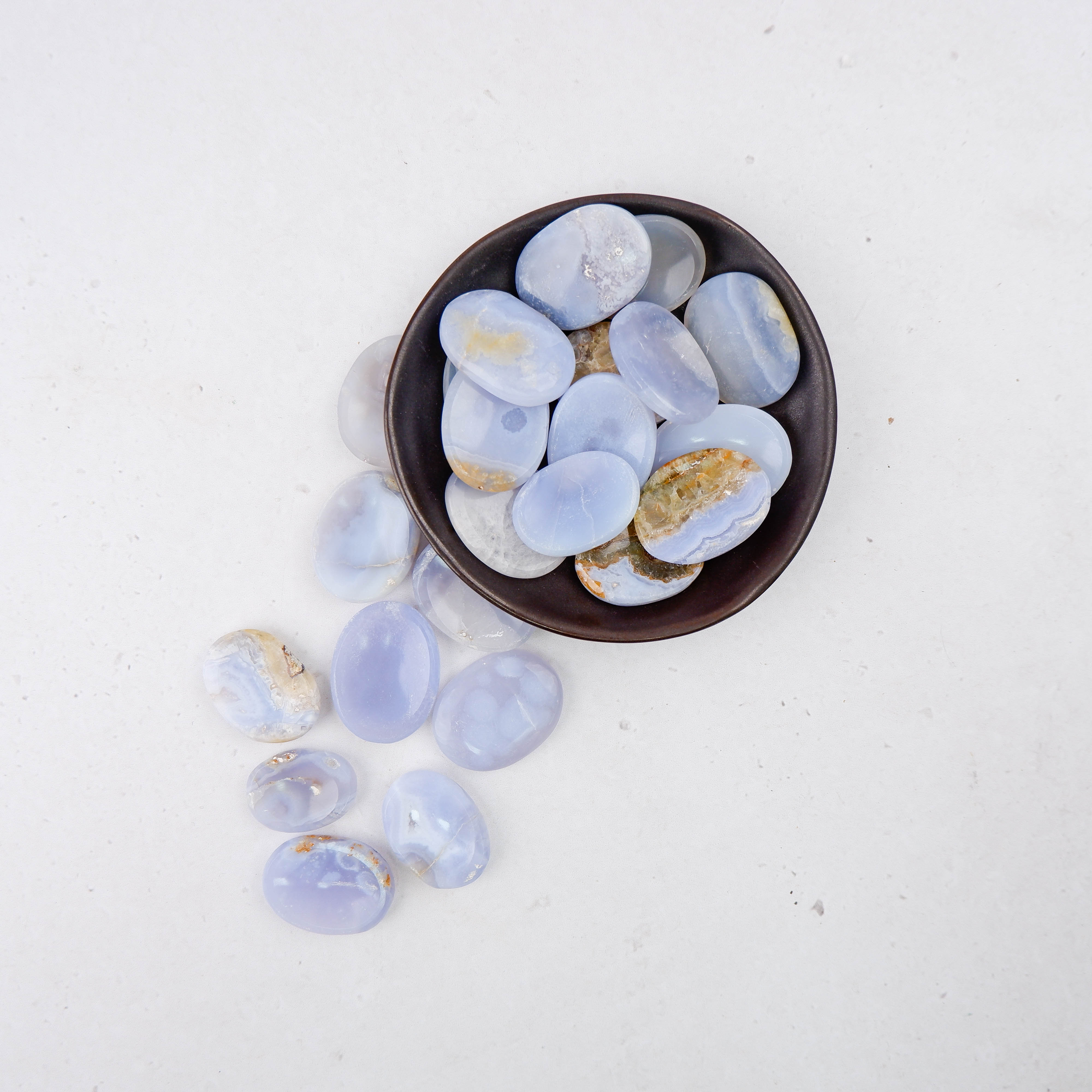 Blue Lace Agate worry stone from Noctis Studio, smooth polished gemstone with intricate blue and white lace patterns.