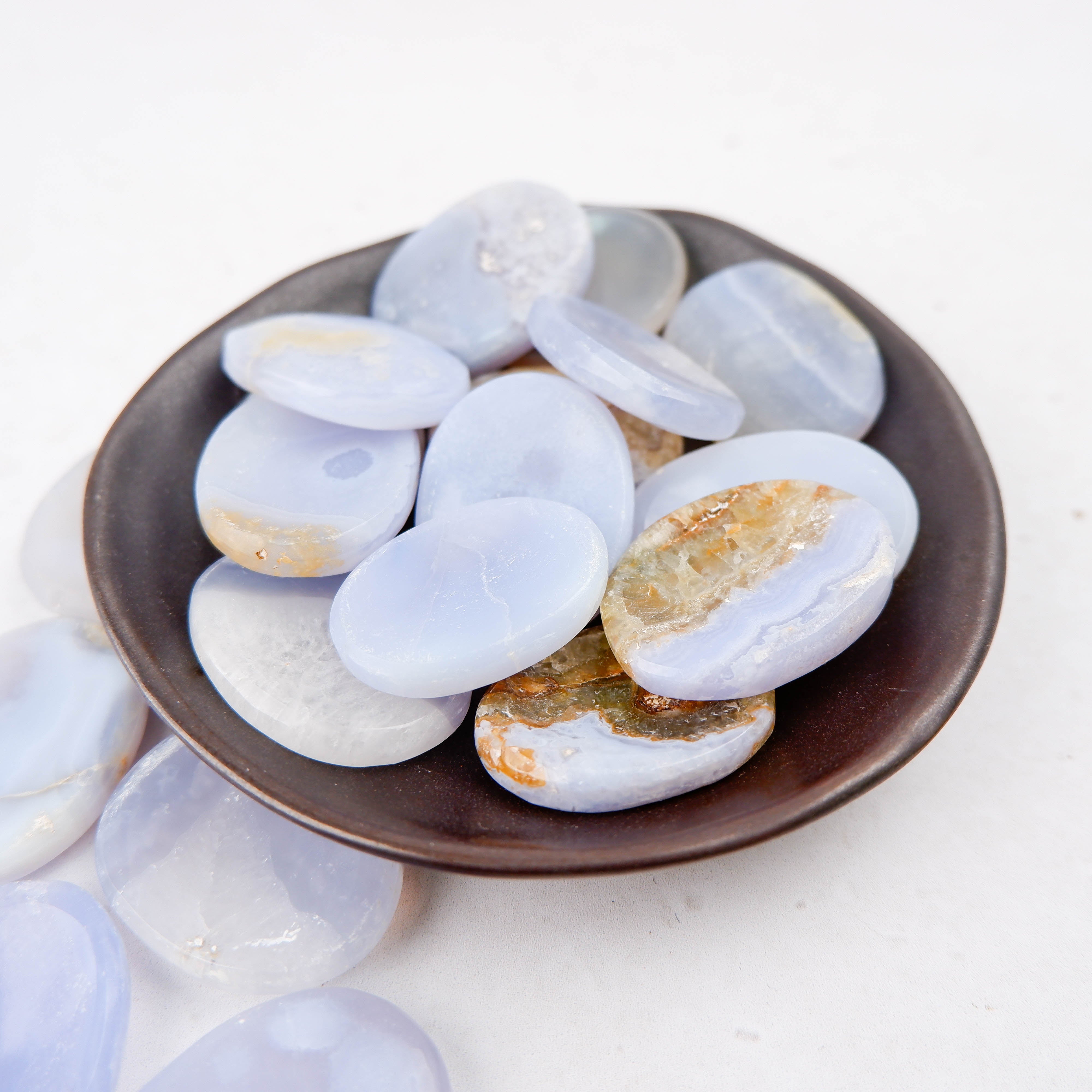 Blue Lace Agate worry stone from Noctis Studio, smooth polished gemstone with intricate blue and white lace patterns.