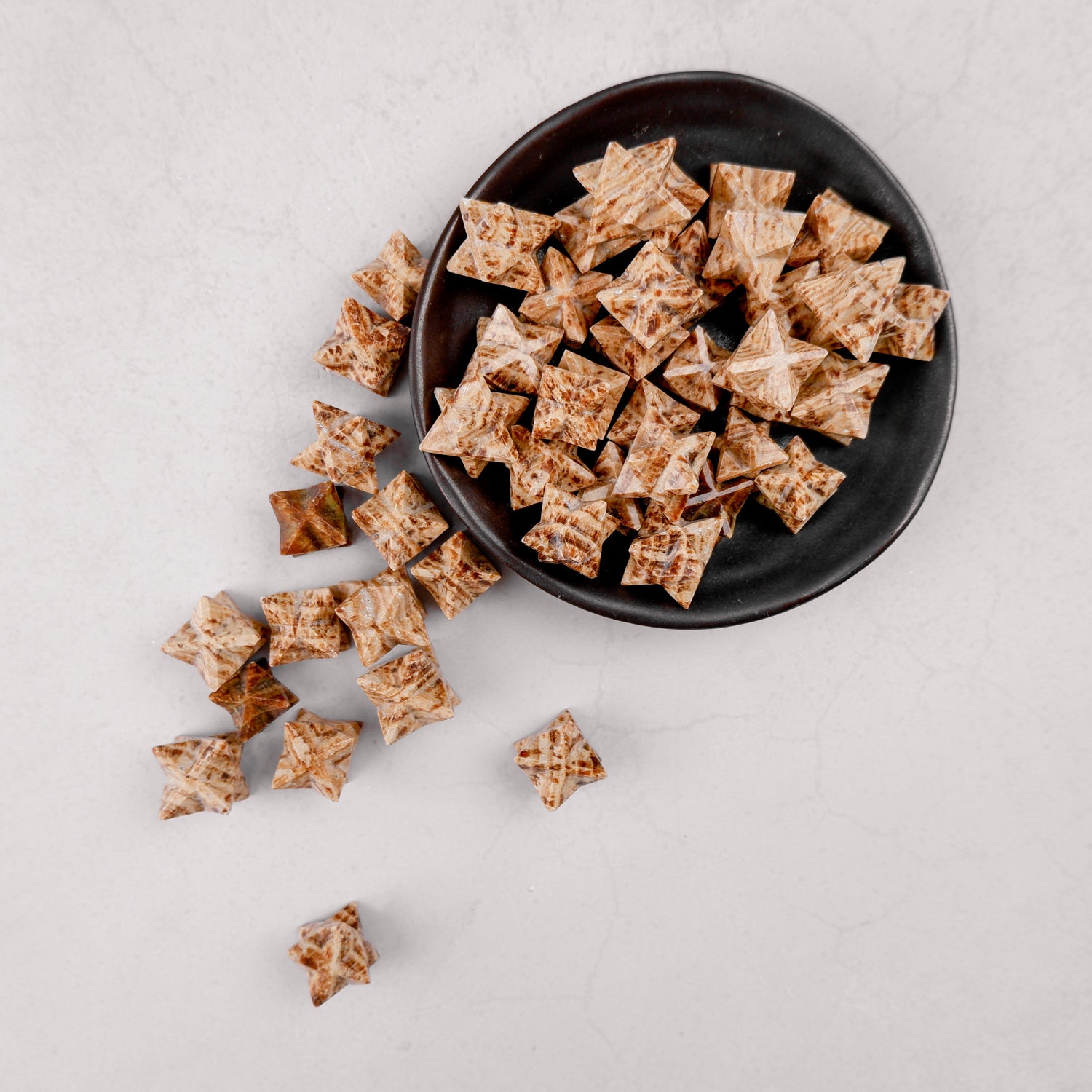 Noctis Studio Aragonite Star mineral specimen with a natural star shape and textured surface on a neutral background.