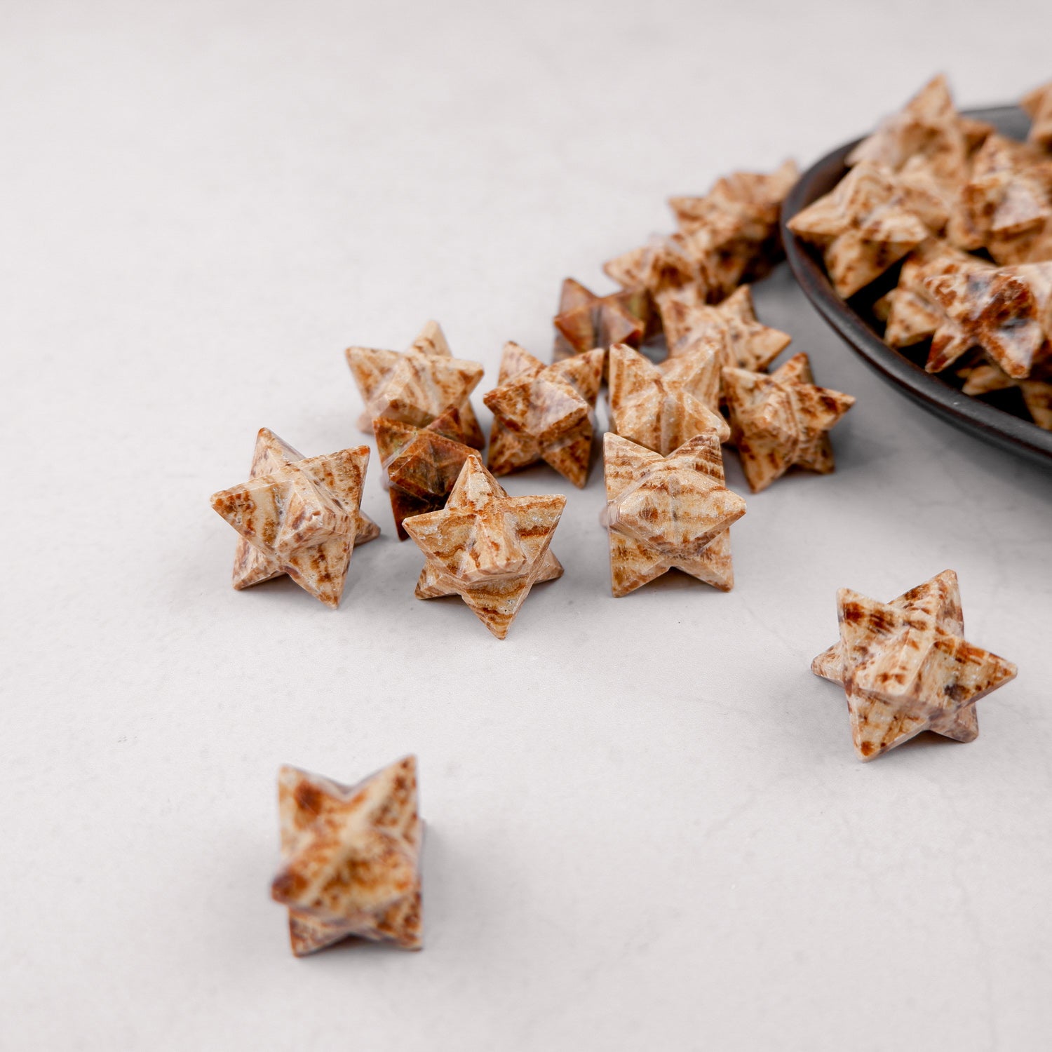 Noctis Studio Aragonite Star mineral specimen featuring a natural star-shaped formation in earthy tones.