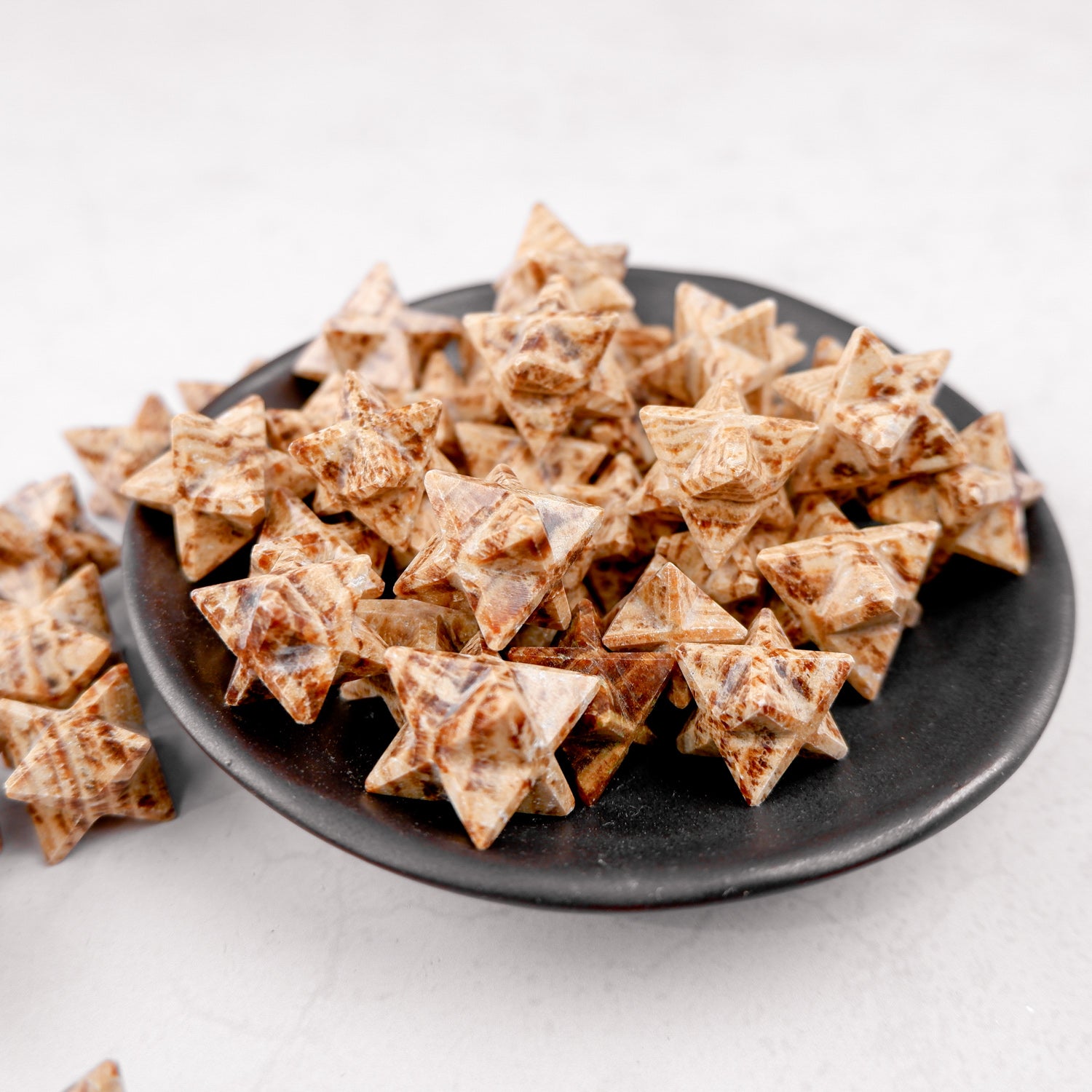 Bright white aragonite star mineral from Noctis Studio, showcasing its natural star shape and textured surface.