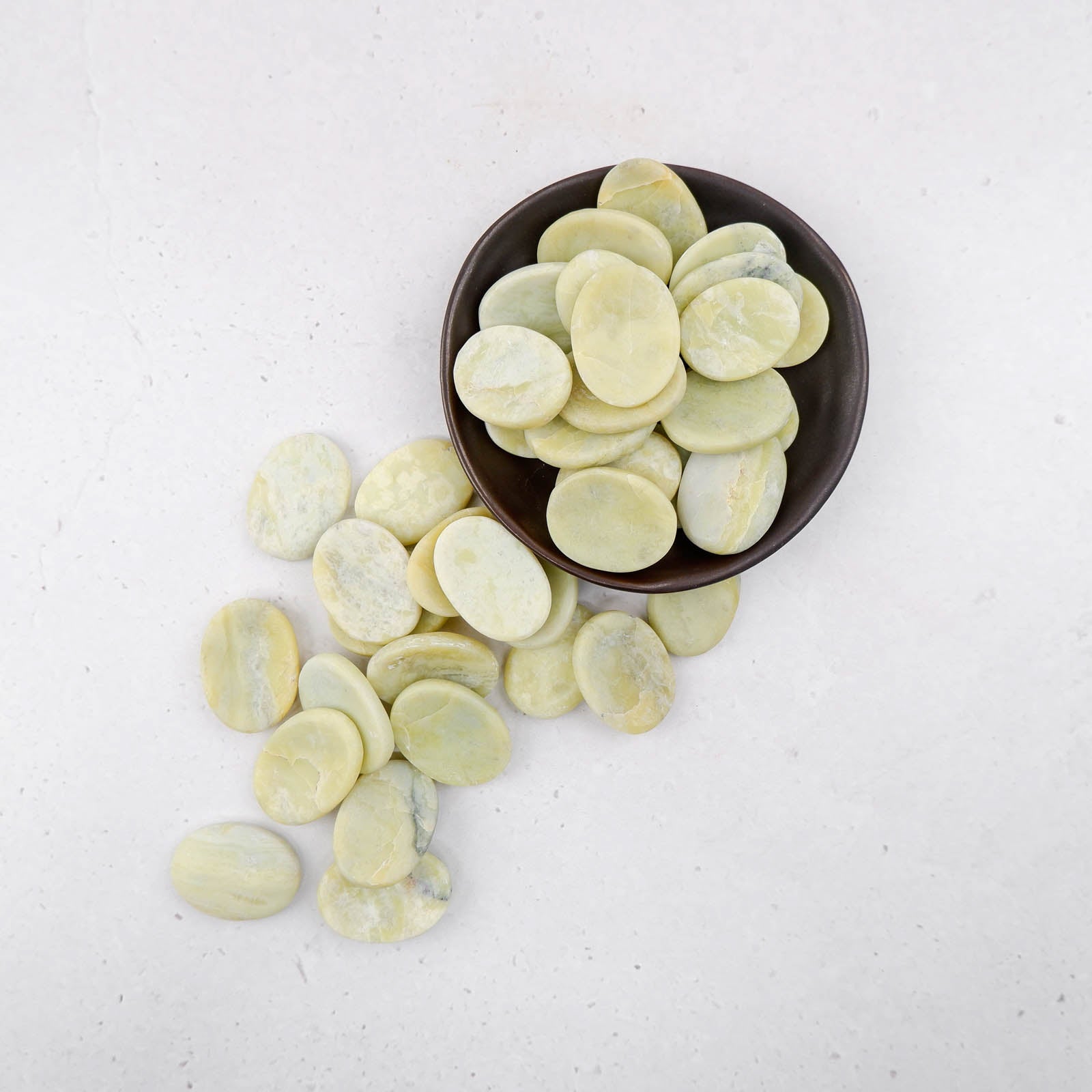 Serpentine worry stone from Noctis Studio, smooth polished gemstone for stress relief and calming grip.