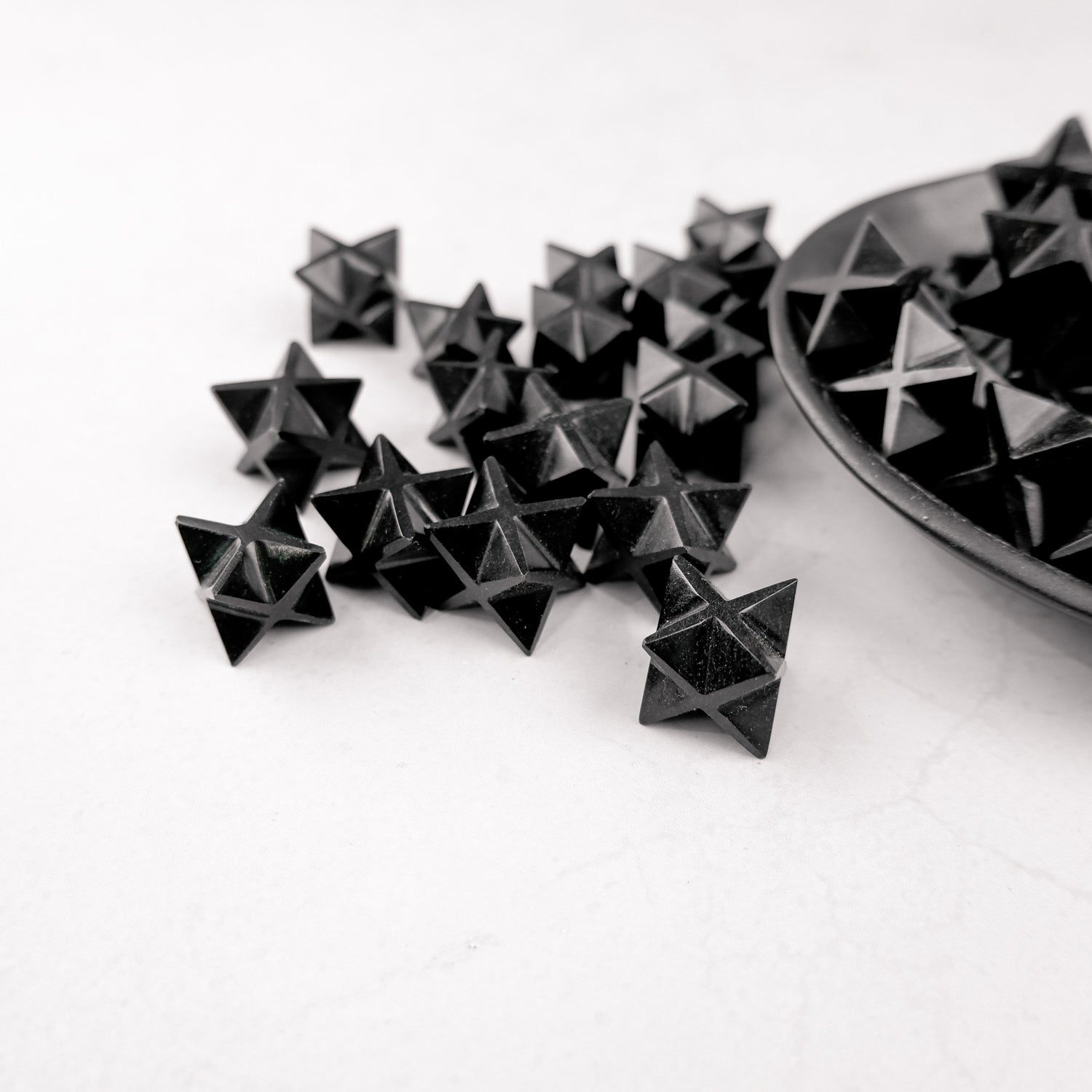 Noctis Studio Obsidian Star sculpture with a smooth, black star-shaped design on a white background.