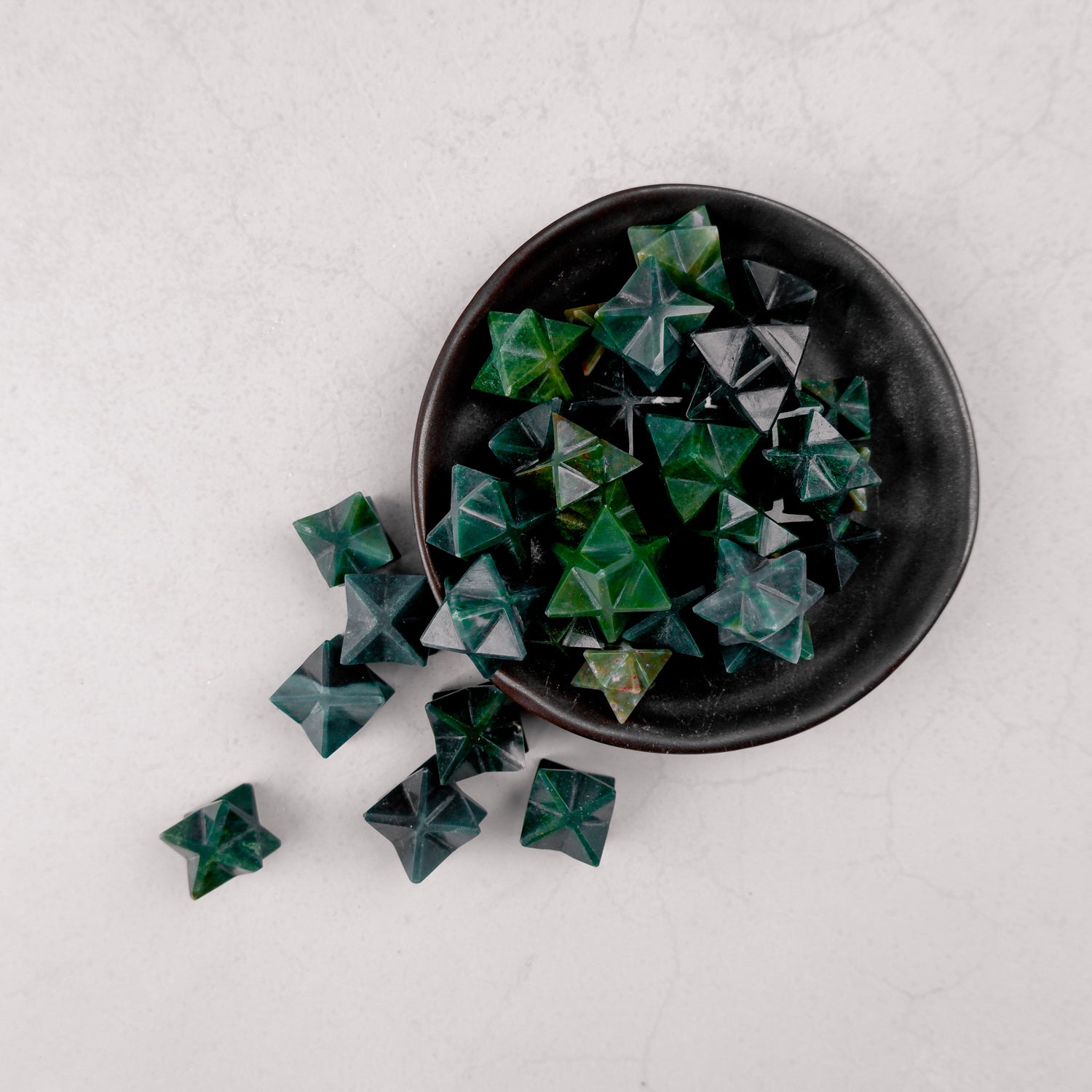Bloodstone Star from Noctis Studio featuring a polished red stone shaped like a star with detailed craftsmanship.