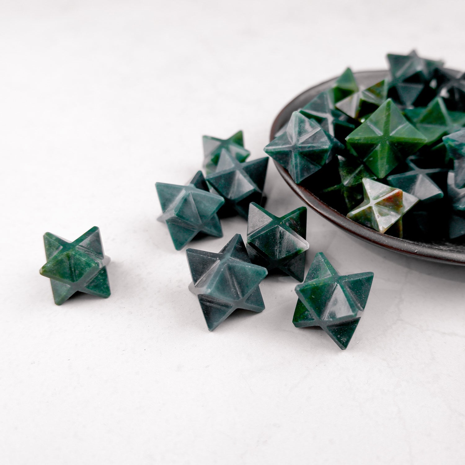 Bloodstone Star by Noctis Studio, a polished red gemstone star-shaped pendant with natural variations and smooth surface.