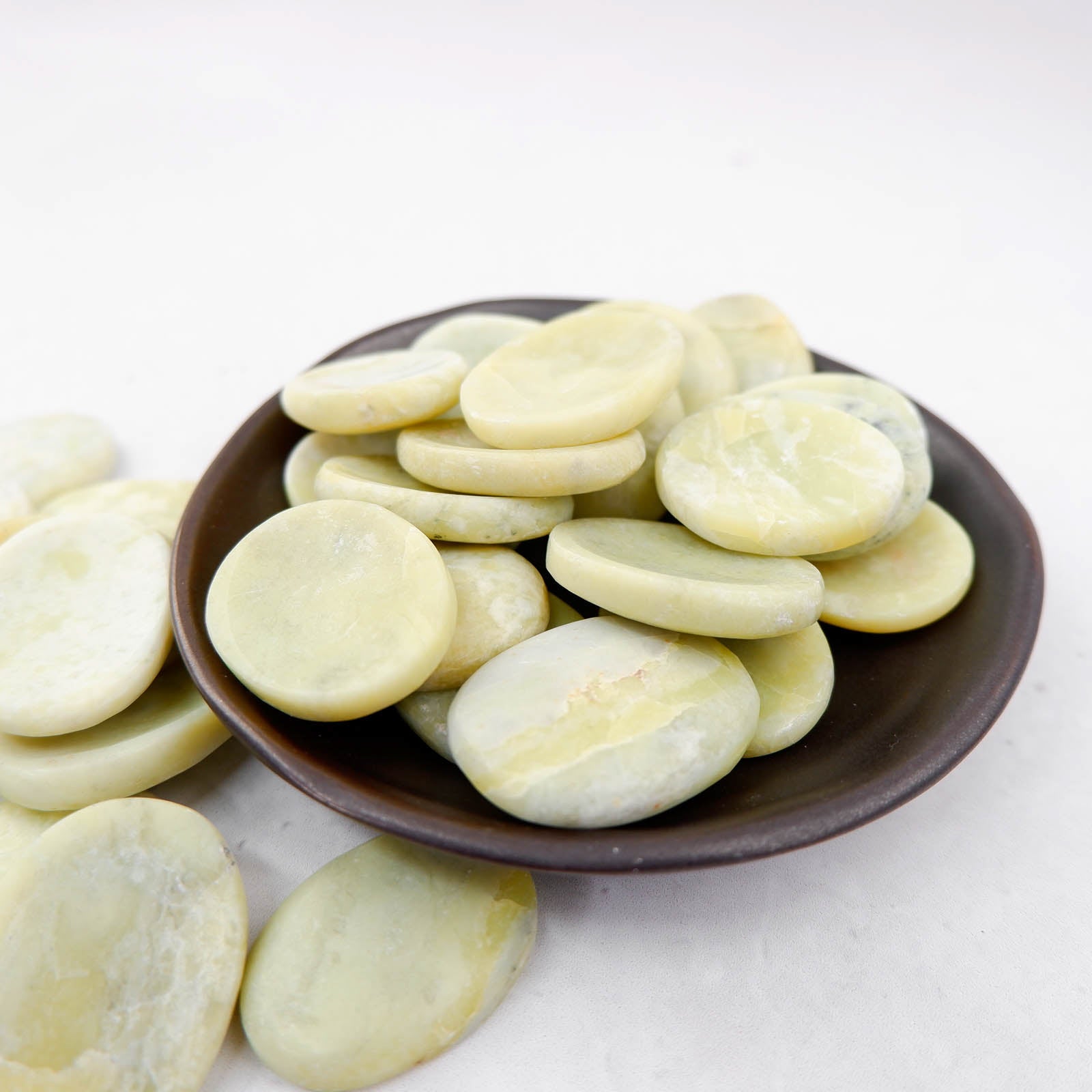 Serpentine worry stone by Noctis Studio, smooth polished gemstone for stress relief, oval shape with natural green and black marbling.
