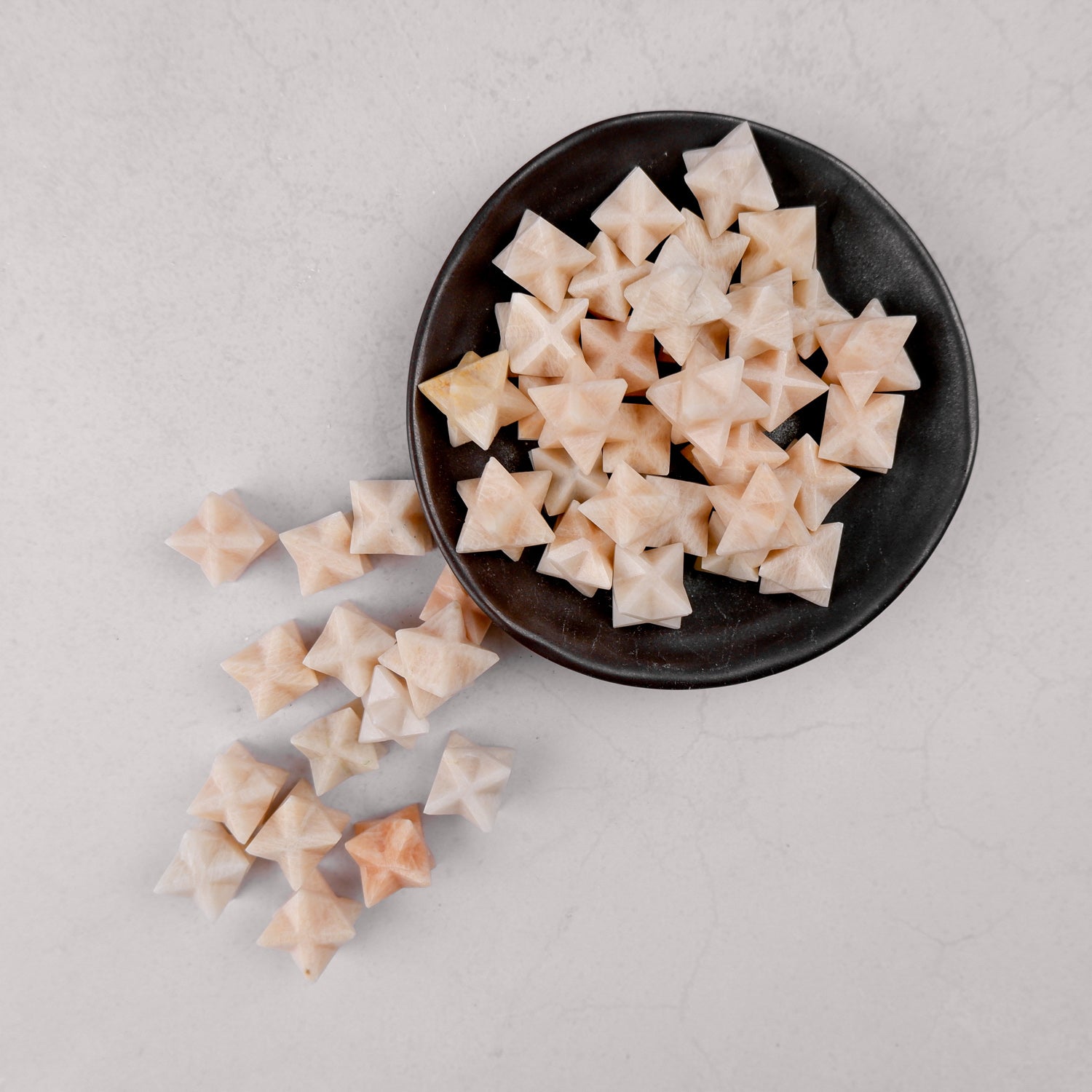 Cream moonstone star jewelry piece with smooth, polished surface, crafted by Noctis Studio.