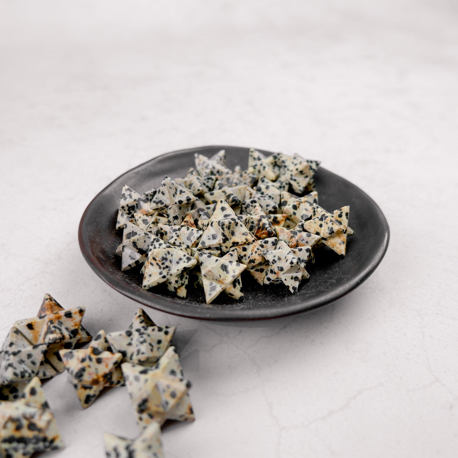 Dalmatian Star figurine by Noctis Studio, showing a star-shaped decorative object with black and white speckled patterns.