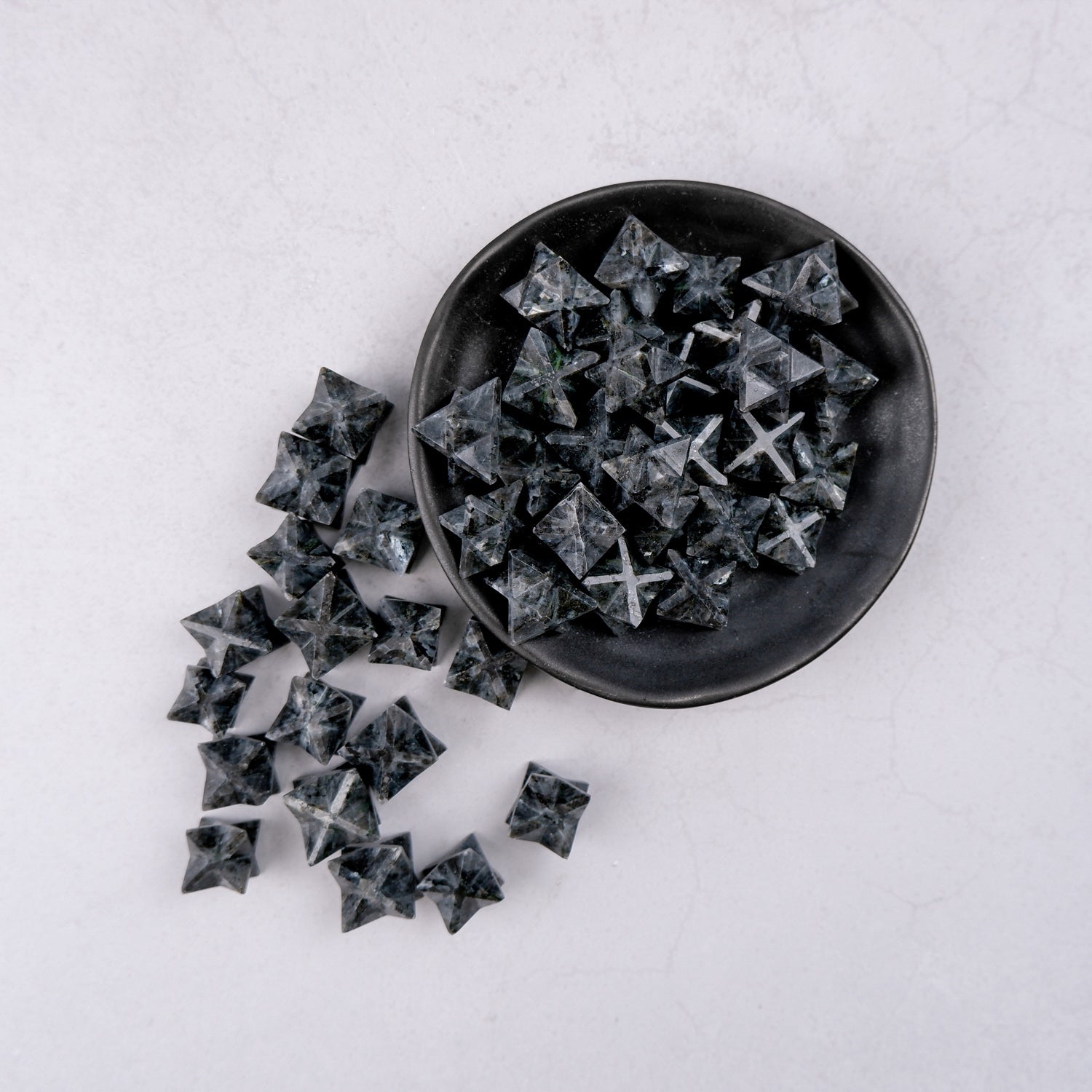 Larvikite Star by Noctis Studio, a polished star-shaped gemstone with dark, iridescent blue and gray hues.