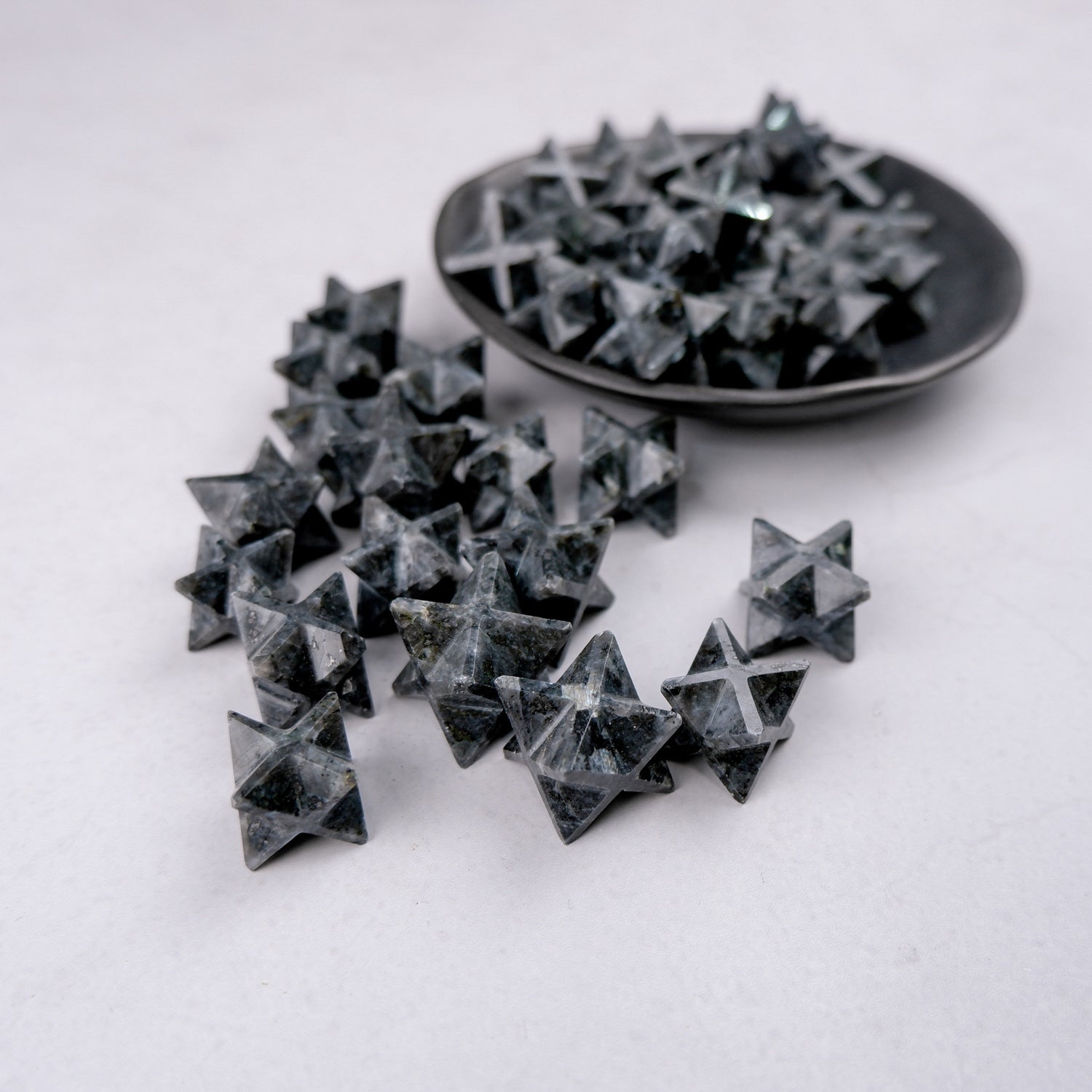 Noctis Studio Larvikite Star sculpture, polished natural stone star with unique dark and blue mineral patterns, on a flat surface.