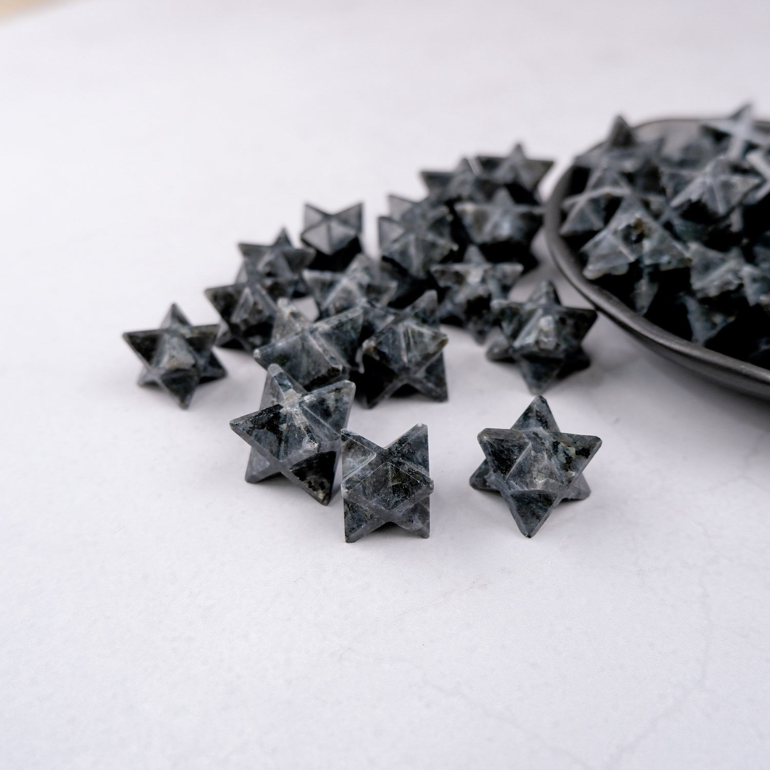 Larvikite star-shaped sculpture by Noctis Studio, featuring polished dark stone with natural blue and silver shimmering details.
