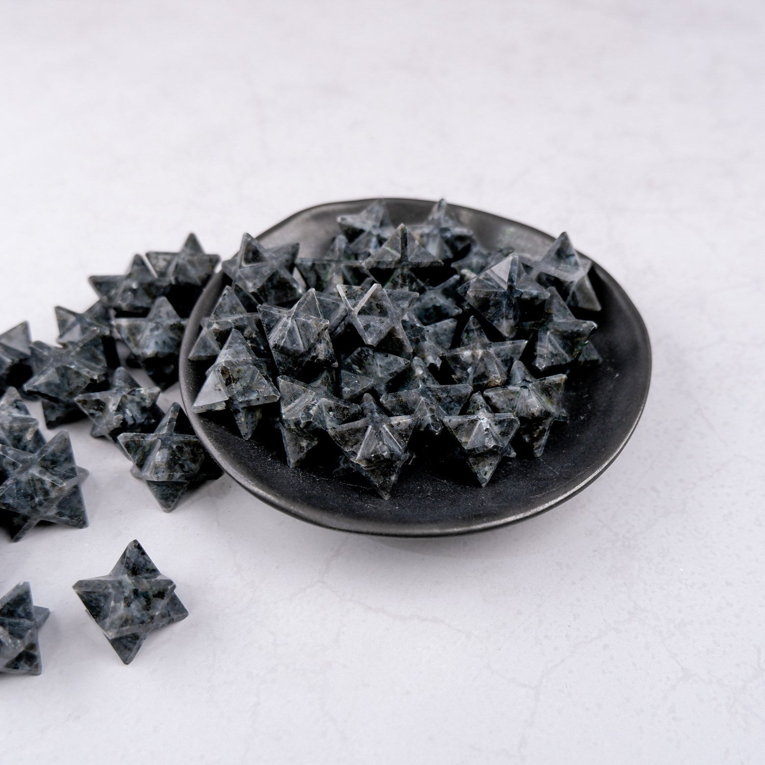 Noctis Studio Larvikite Star sculpture showing a polished, star-shaped stone with blue and gray patterns on a white background.