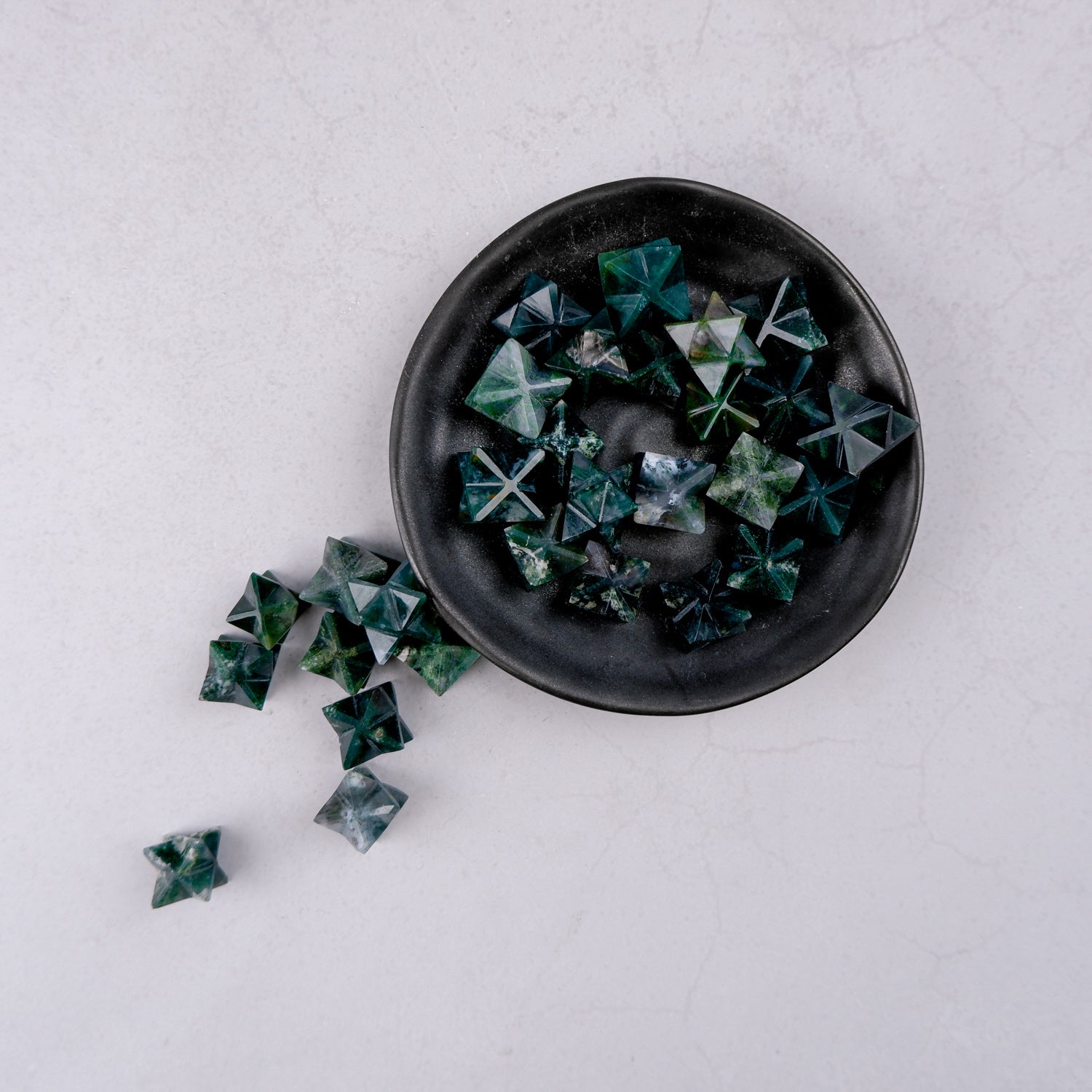 Moss Agate star gemstone from Noctis Studio, featuring a polished star-shaped moss agate stone with intricate green and brown patterns.