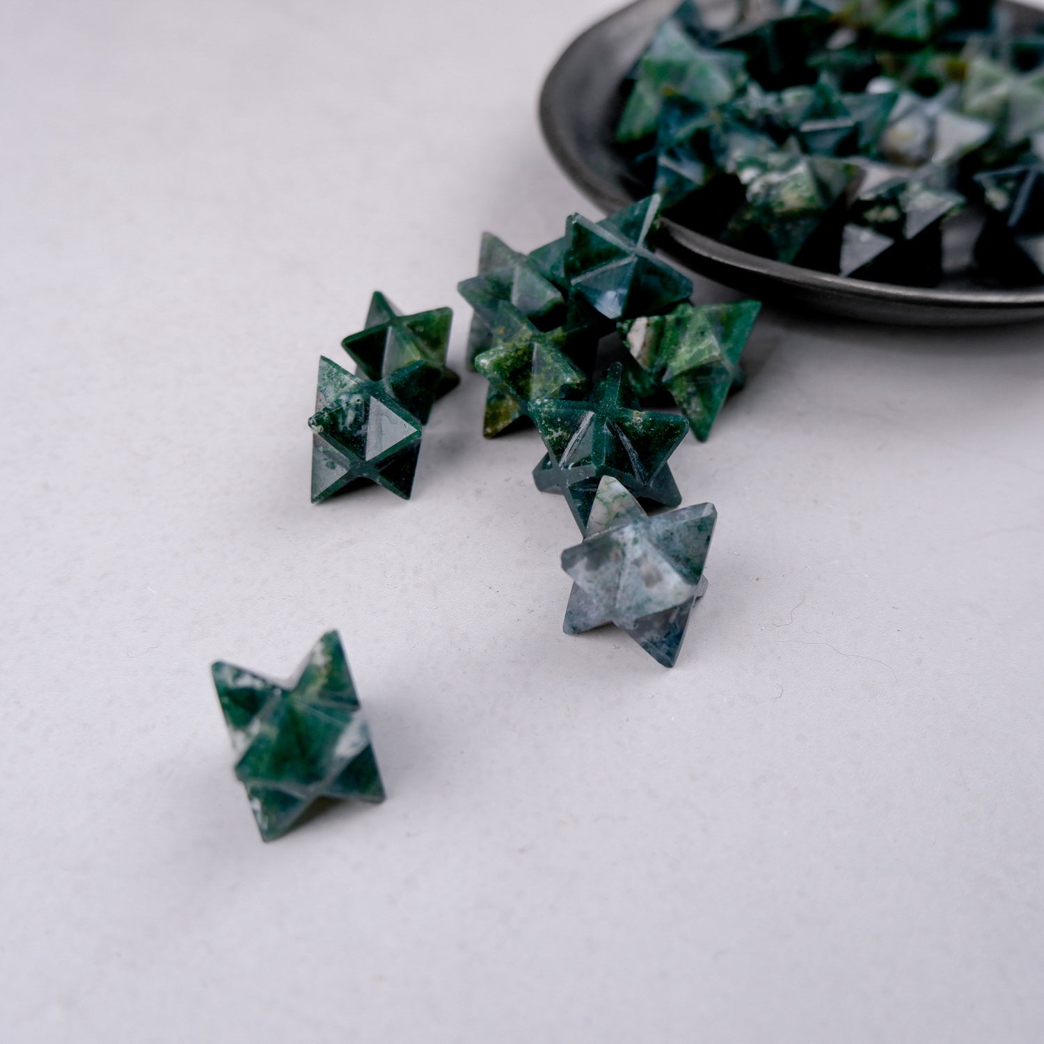 Moss Agate star gemstone by Noctis Studio, showcasing green and brown moss-like patterns in a polished star shape.