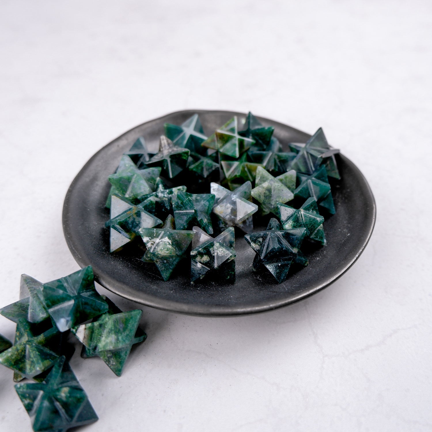 Moss agate star gemstone pendant by Noctis Studio, featuring a polished natural stone with green moss-like inclusions on a white background.