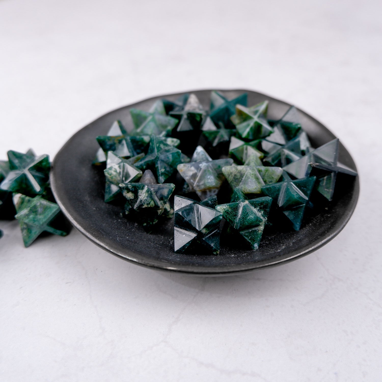 Moss Agate Star gemstone from Noctis Studio, polished star-shaped mineral with green and brown moss-like inclusions.
