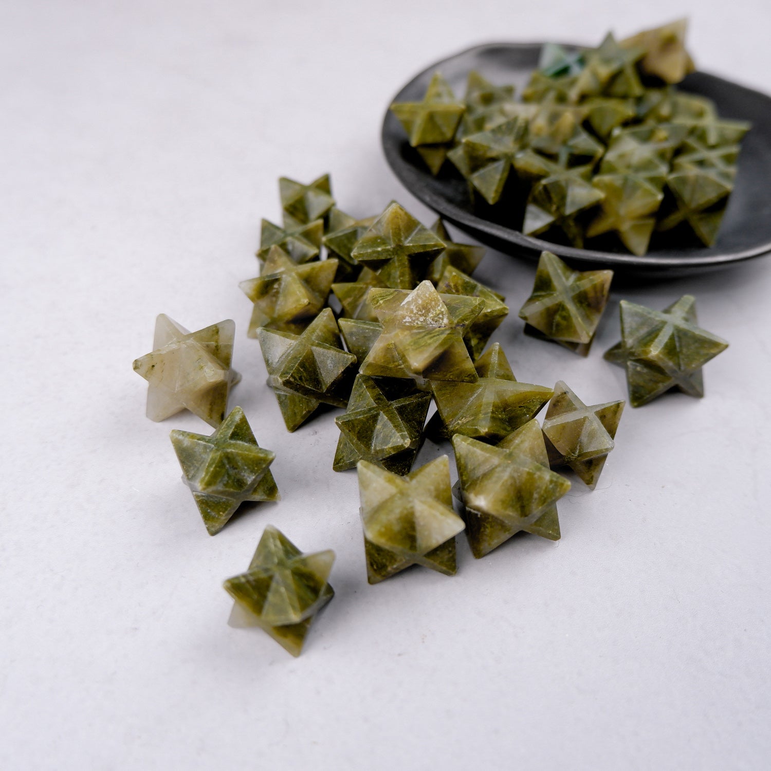 Green Jasper star sculpture by Noctis Studio showing a polished green jasper star with natural patterns and smooth finish.