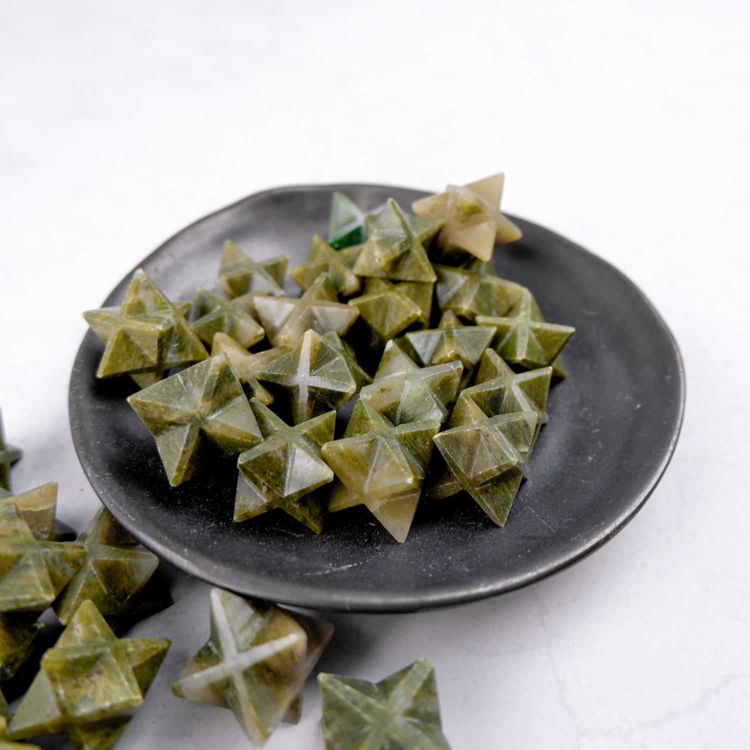 Green Jasper Star from Noctis Studio, a polished gemstone with a star shape, showcasing vibrant green hues and natural patterns.