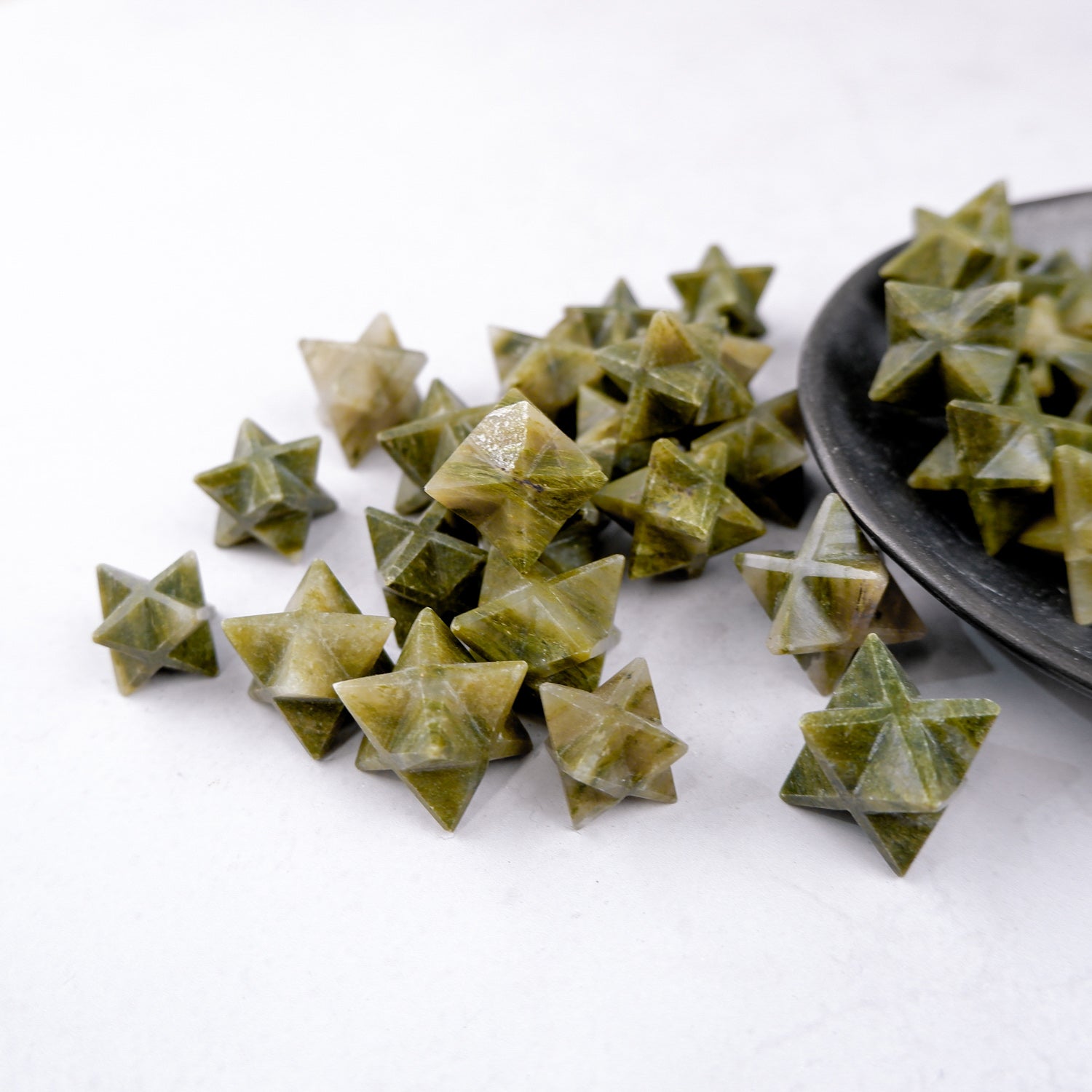 Green Jasper star sculpture by Noctis Studio, polished stone with vibrant green hues and natural patterns, displayed against a neutral background.