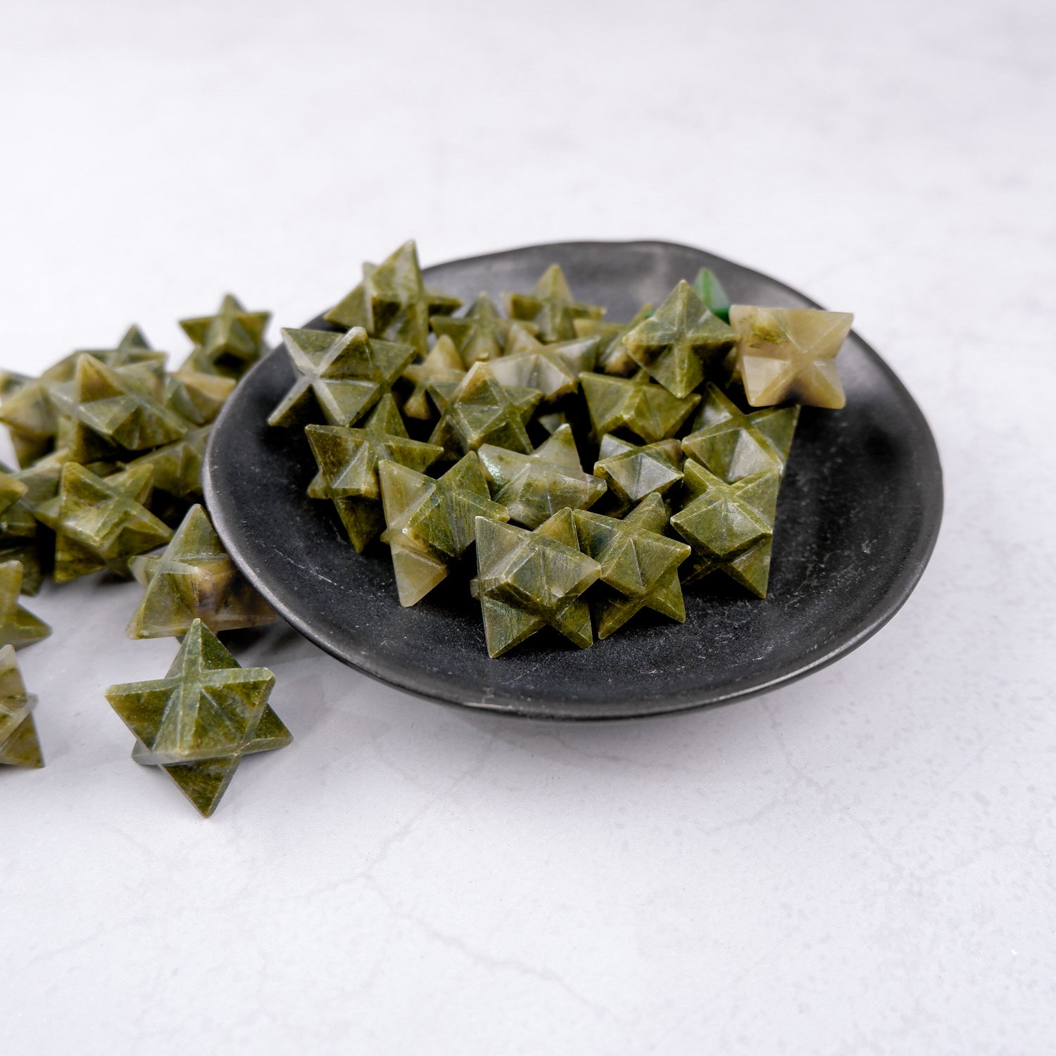 Green Jasper star sculpture by Noctis Studio, intricately carved green stone star with natural patterns and polished finish.