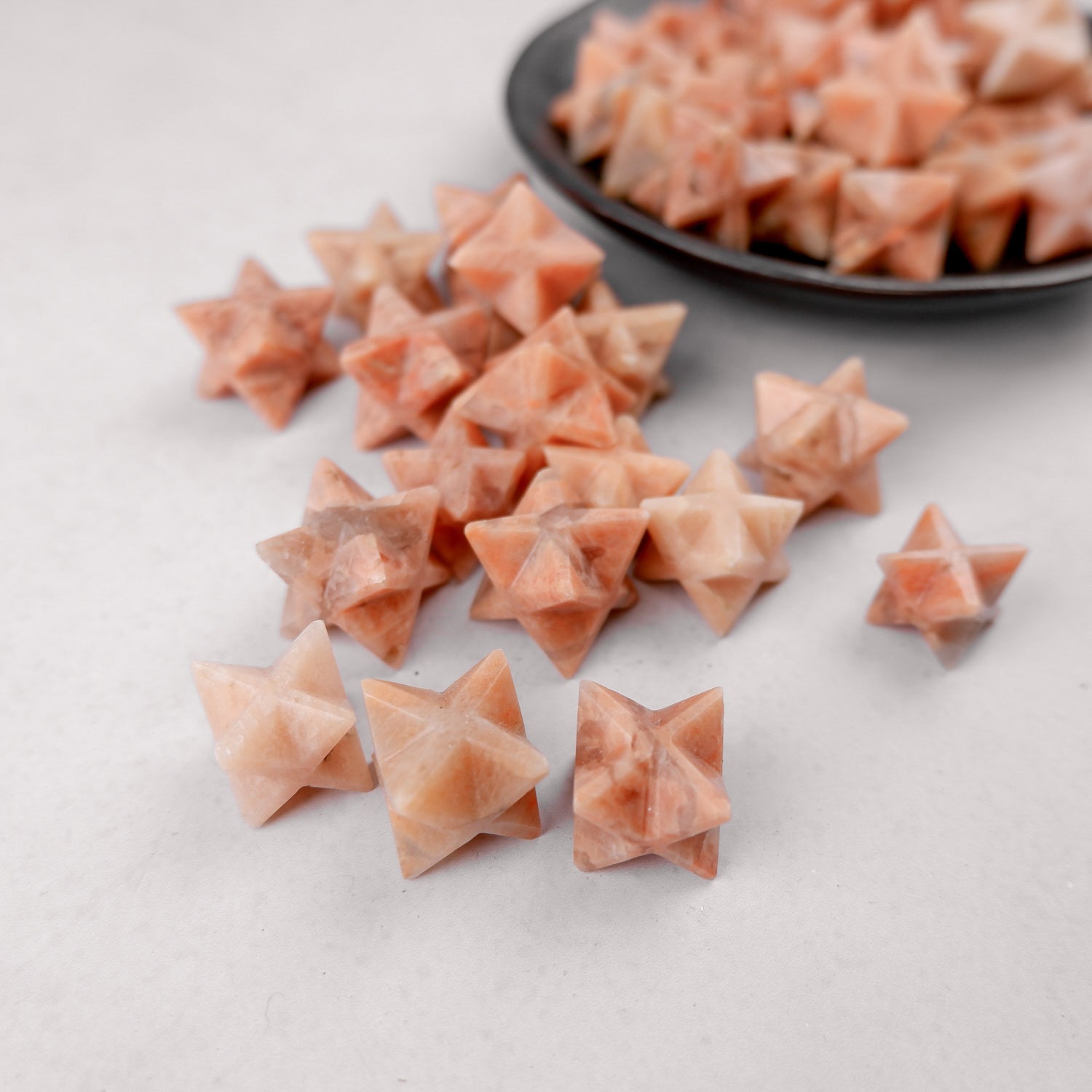 Orange Moonstone star pendant by Noctis Studio, featuring a polished star-shaped gemstone with vibrant orange hues and natural shimmer.