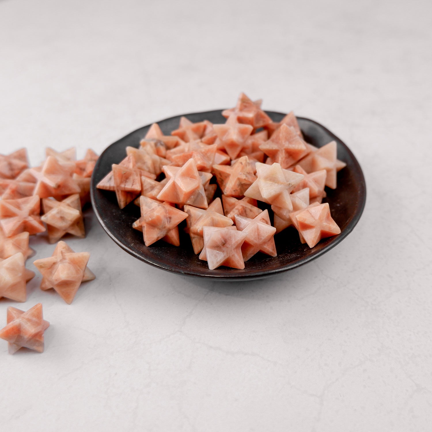Orange Moonstone star-shaped gemstone from Noctis Studio, showcasing its vibrant color and natural star shimmer.