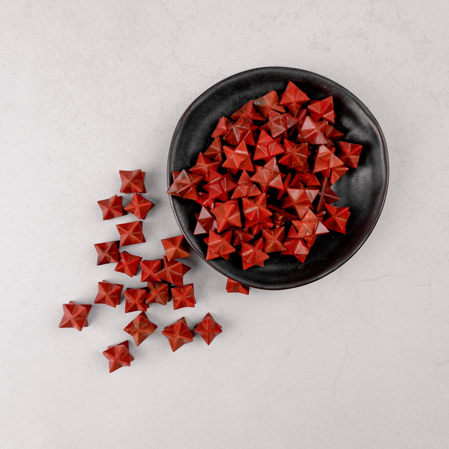 Red Jasper star-shaped gemstone from Noctis Studio, featuring a polished red jasper surface with natural patterns and a smooth finish.