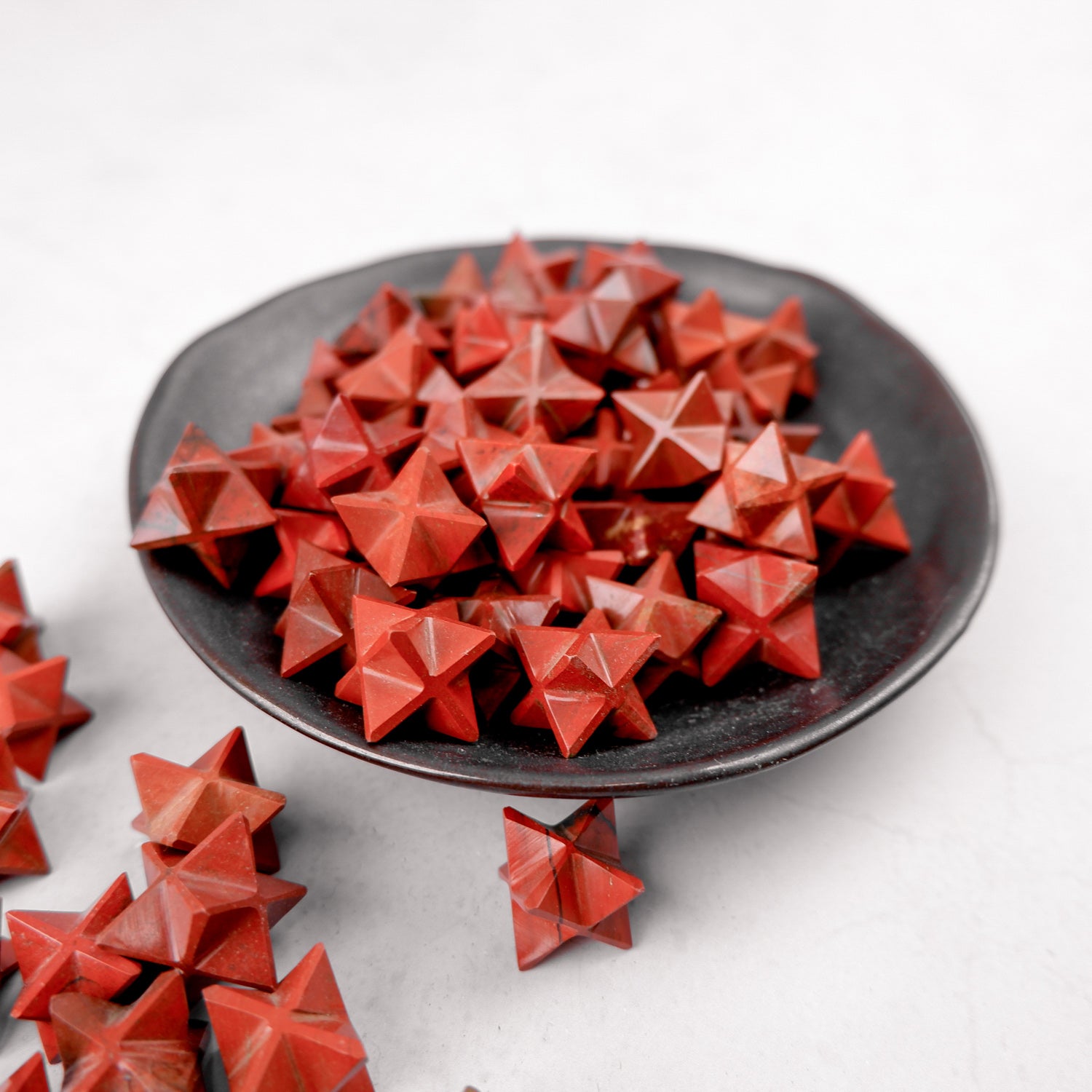 Red Jasper star sculpture by Noctis Studio, featuring a polished, vibrant red gemstone star with natural patterns and smooth surface.