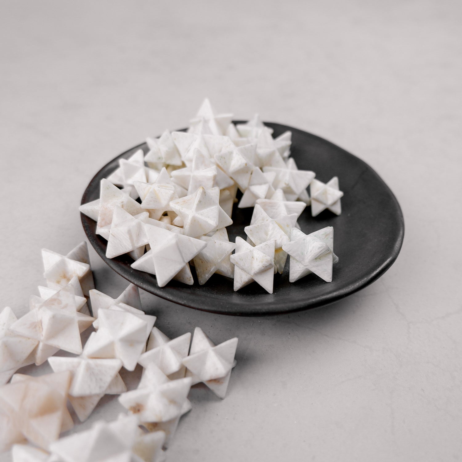 Scolecite star mineral from Noctis Studio, featuring a natural star-shaped crystal with delicate formations and a smooth surface.