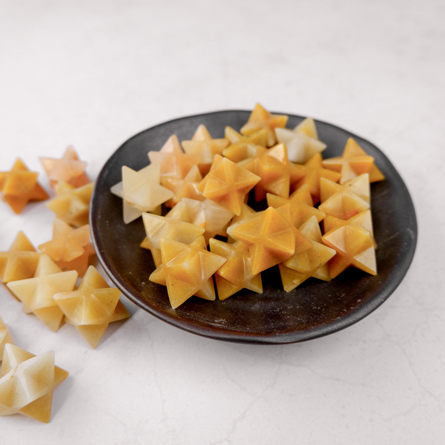 Yellow aventurine star sculpture by Noctis Studio, features a polished yellow gemstone star with natural veining and smooth surfaces.